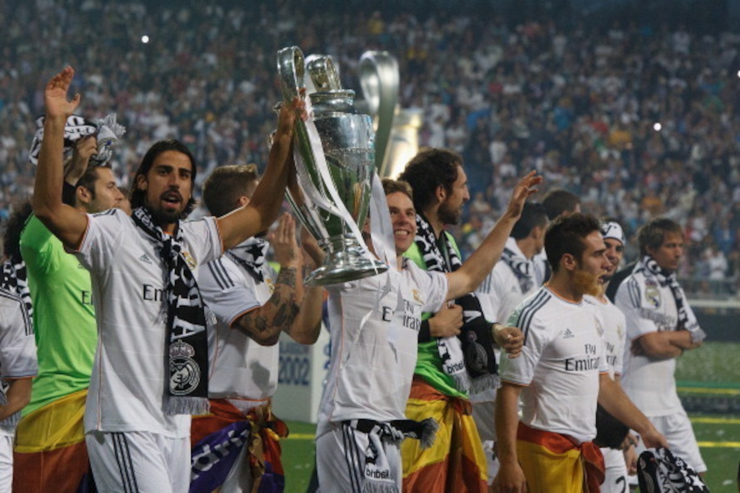 MADRID, SPAIN - MAY 25:  Real Madrid player Sami Khedira (L) lifts the trophy during the Real Madrid celebration the day after winning the UEFA Champions League final at Santiago Bernabeu Stadium on May 25, 2014 in Madrid, Spain. Real Madrid CF achieves t