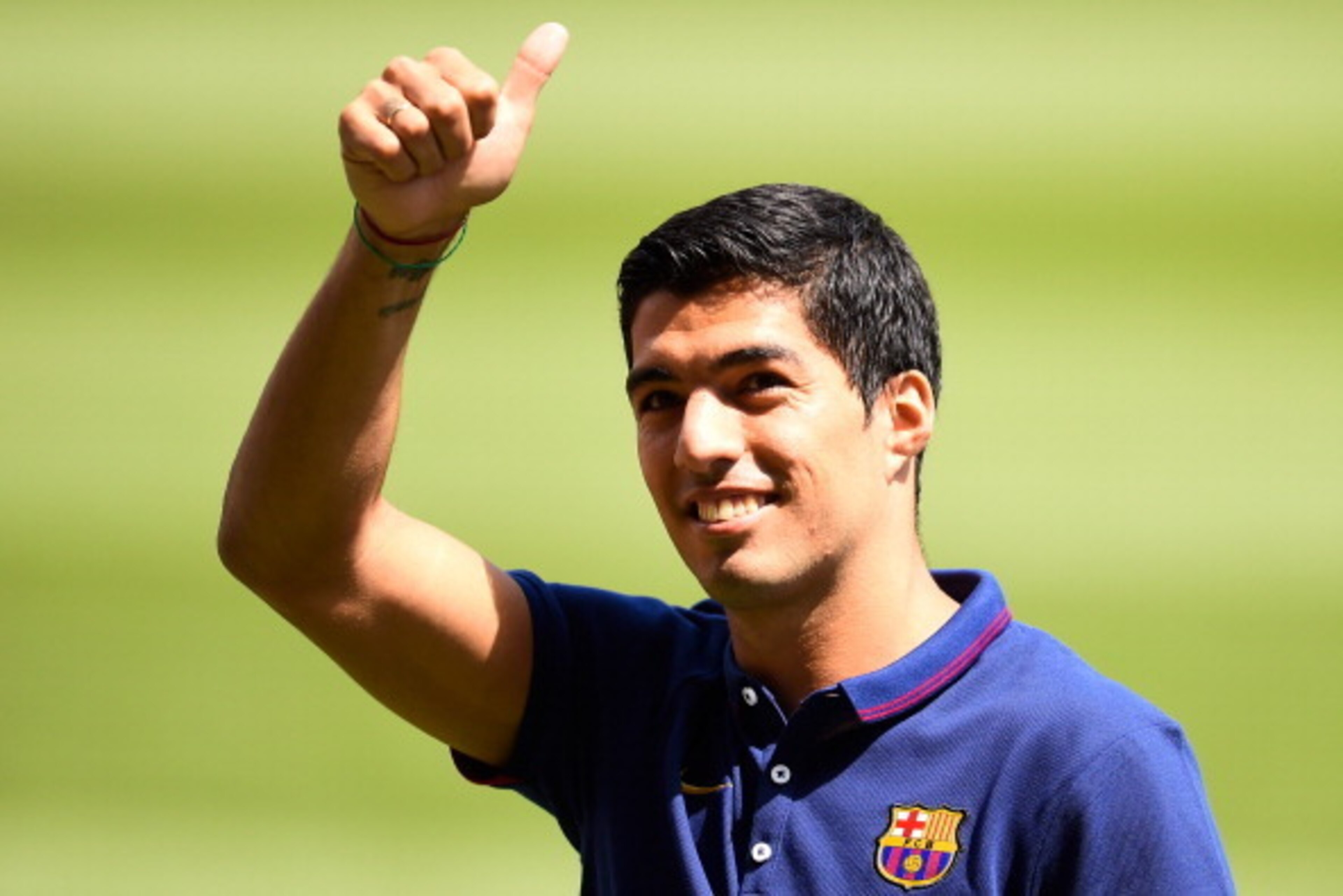 BARCELONA, SPAIN - AUGUST 19:  Luis Suarez of FC Barcelona gives his thumbs up during his presentation as new FC Barcelona player at Camp Nou on August 19, 2014 in Barcelona, Spain.  (Photo by David Ramos/Getty Images)