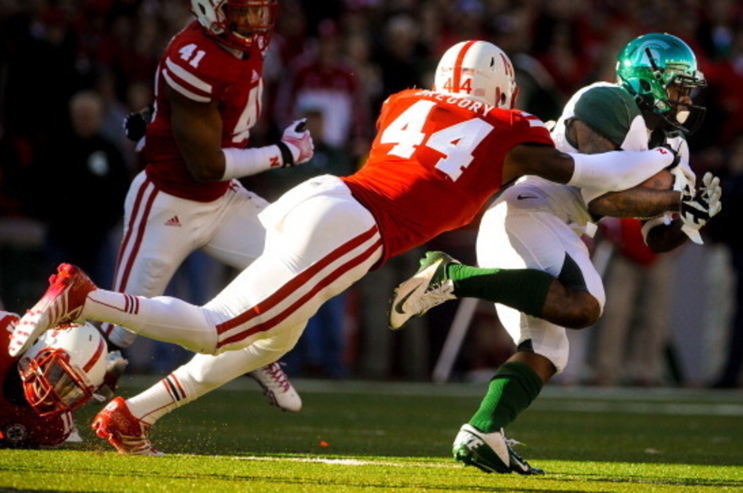 LINCOLN, NE - NOVEMBER 16: Defensive end Randy Gregory #44 of the Nebraska Cornhuskers dives for running back Jeremy Langford #33 of the Michigan State Spartans during their game at Memorial Stadium on November 16, 2013 in Lincoln, Nebraska. (Photo by Eri