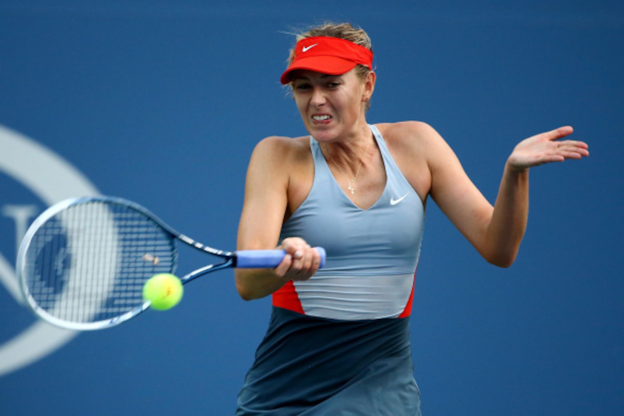 NEW YORK, NY - AUGUST 27:  Maria Sharapova of Russia returns a shot against Alexandra Dulgheru of Romania during their women's singles second round match on Day Three of the 2014 US Open at the USTA Billie Jean King National Tennis Center on August 27, 20