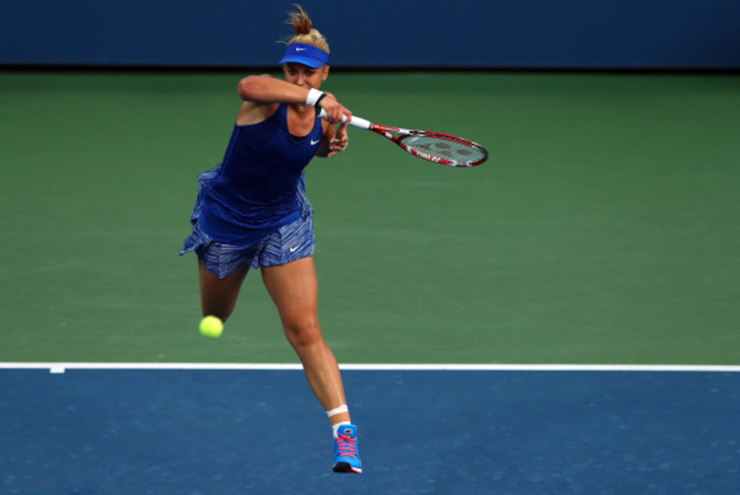 NEW YORK, NY - AUGUST 27:  Sabine Lisicki of Germany returns a shot against Madison Brengle of the United States on Day Three of the 2014 US Open at the USTA Billie Jean King National Tennis Center on August 27, 2014  in the Flushing neighborhood of the Q