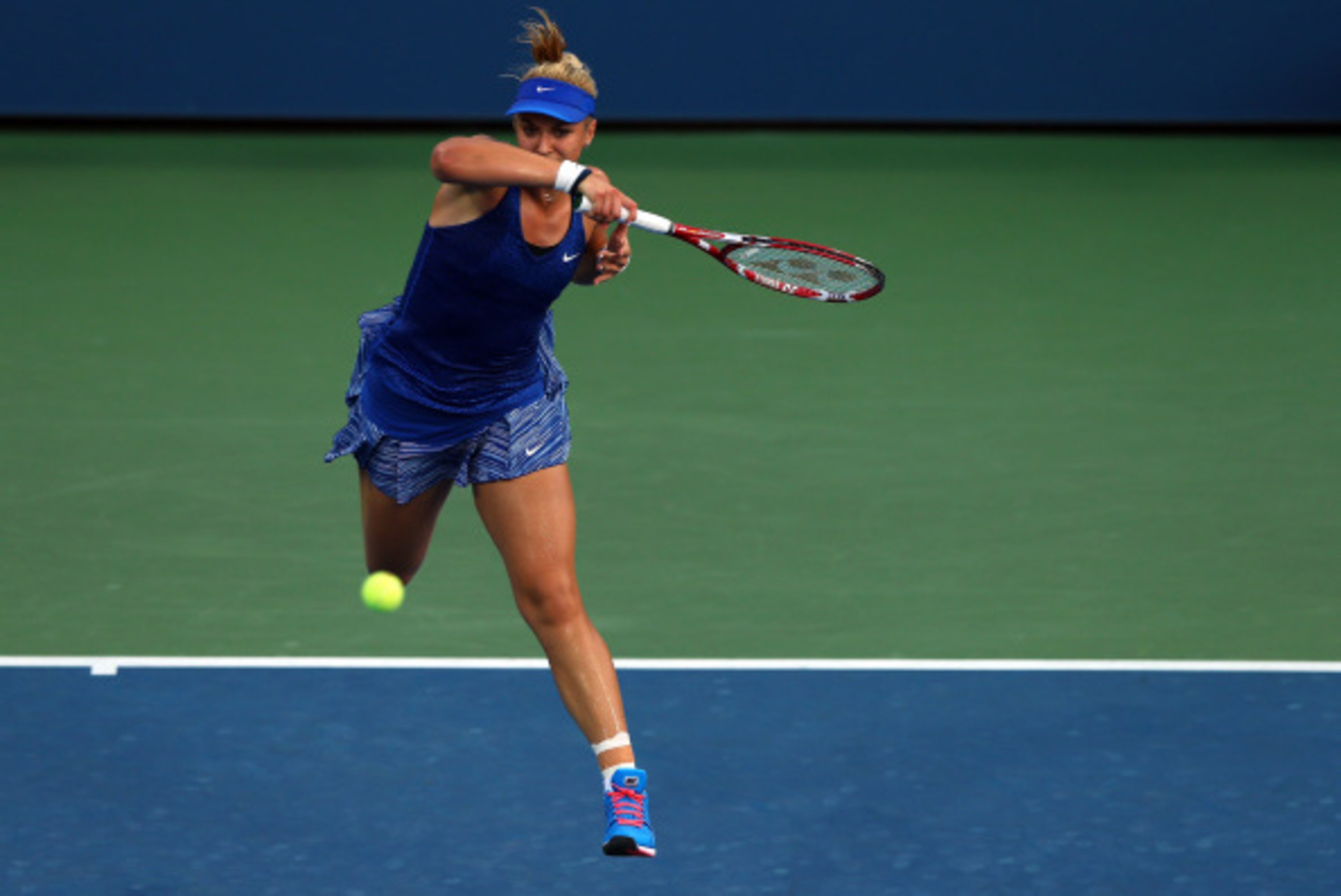 NEW YORK, NY - AUGUST 27:  Sabine Lisicki of Germany returns a shot against Madison Brengle of the United States on Day Three of the 2014 US Open at the USTA Billie Jean King National Tennis Center on August 27, 2014  in the Flushing neighborhood of the Q