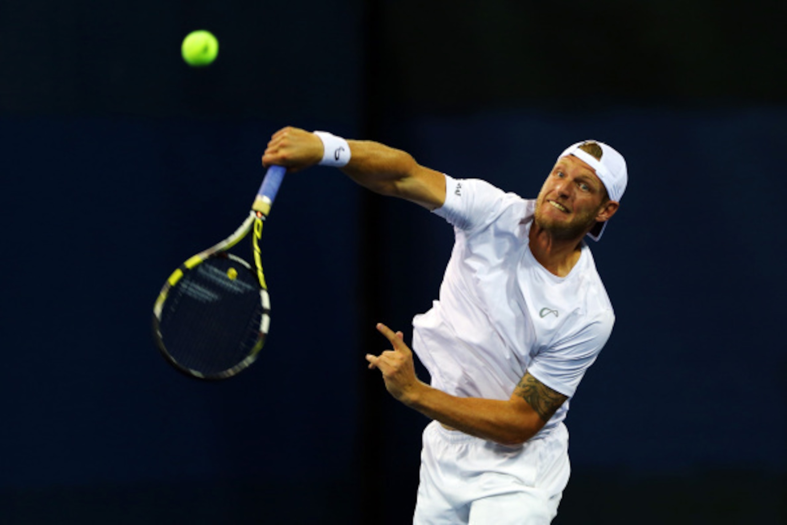 NEW YORK, NY - AUGUST 27:  Sam Groth of Australia serves against Jonathan Marray and Gilles Muller during his men's doubles first round match on Day Three of the 2014 US Open at the USTA Billie Jean King National Tennis Center on August 27, 2014  in the F