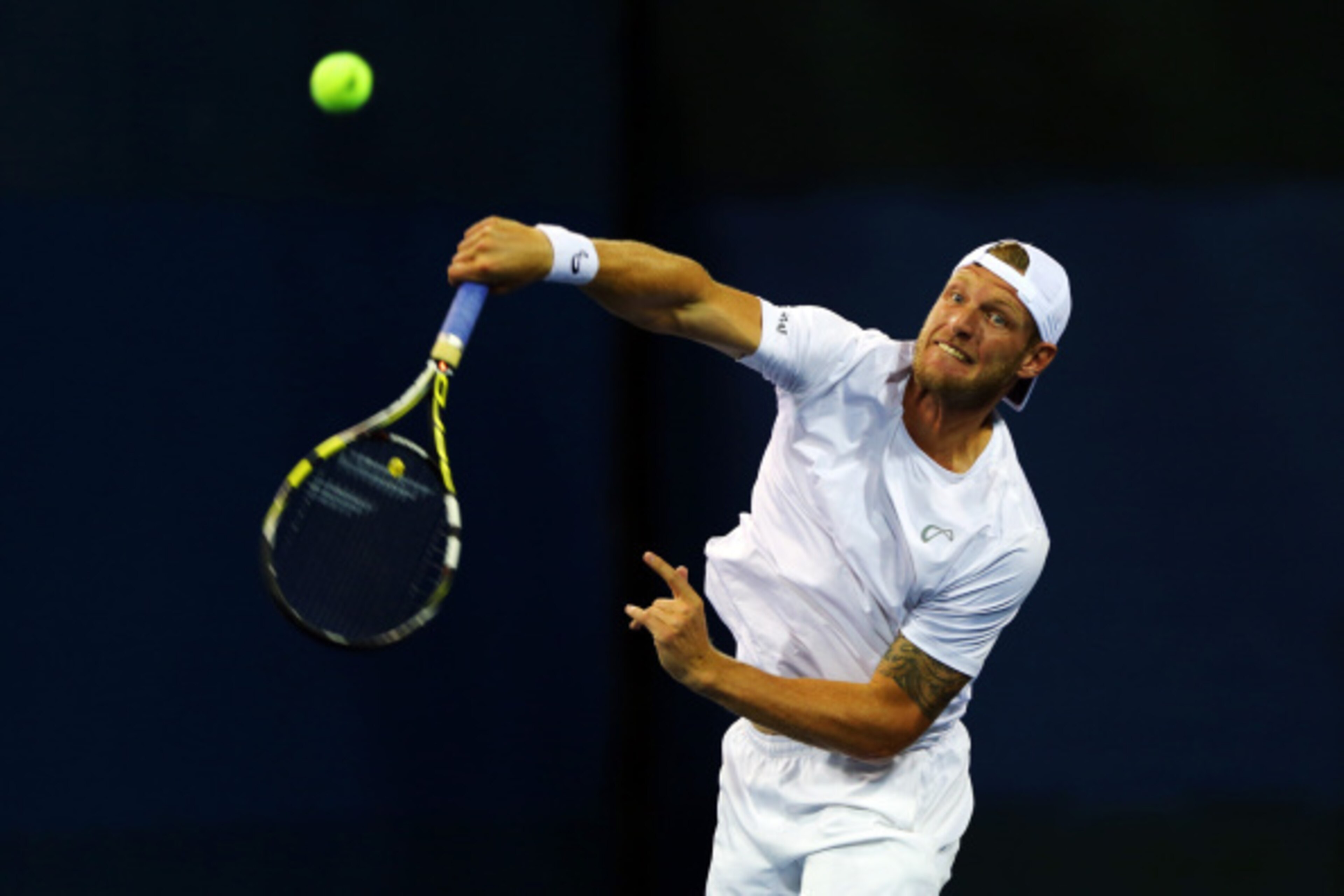 NEW YORK, NY - AUGUST 27:  Sam Groth of Australia serves against Jonathan Marray and Gilles Muller during his men's doubles first round match on Day Three of the 2014 US Open at the USTA Billie Jean King National Tennis Center on August 27, 2014  in the F