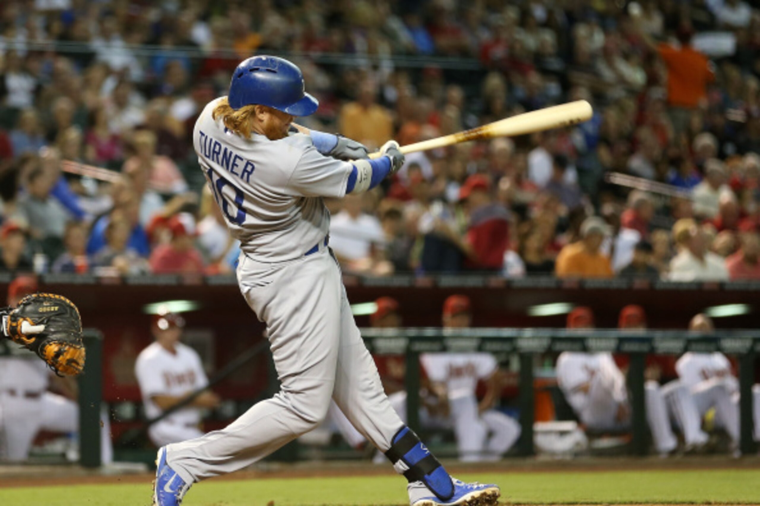 PHOENIX, AZ - AUGUST 26:  Justin Turner #10 of the Los Angeles Dodgers hits a RBI single against the Arizona Diamondbacks during the fourth inning of the MLB game at Chase Field on August 26, 2014 in Phoenix, Arizona.  (Photo by Christian Petersen/Getty I