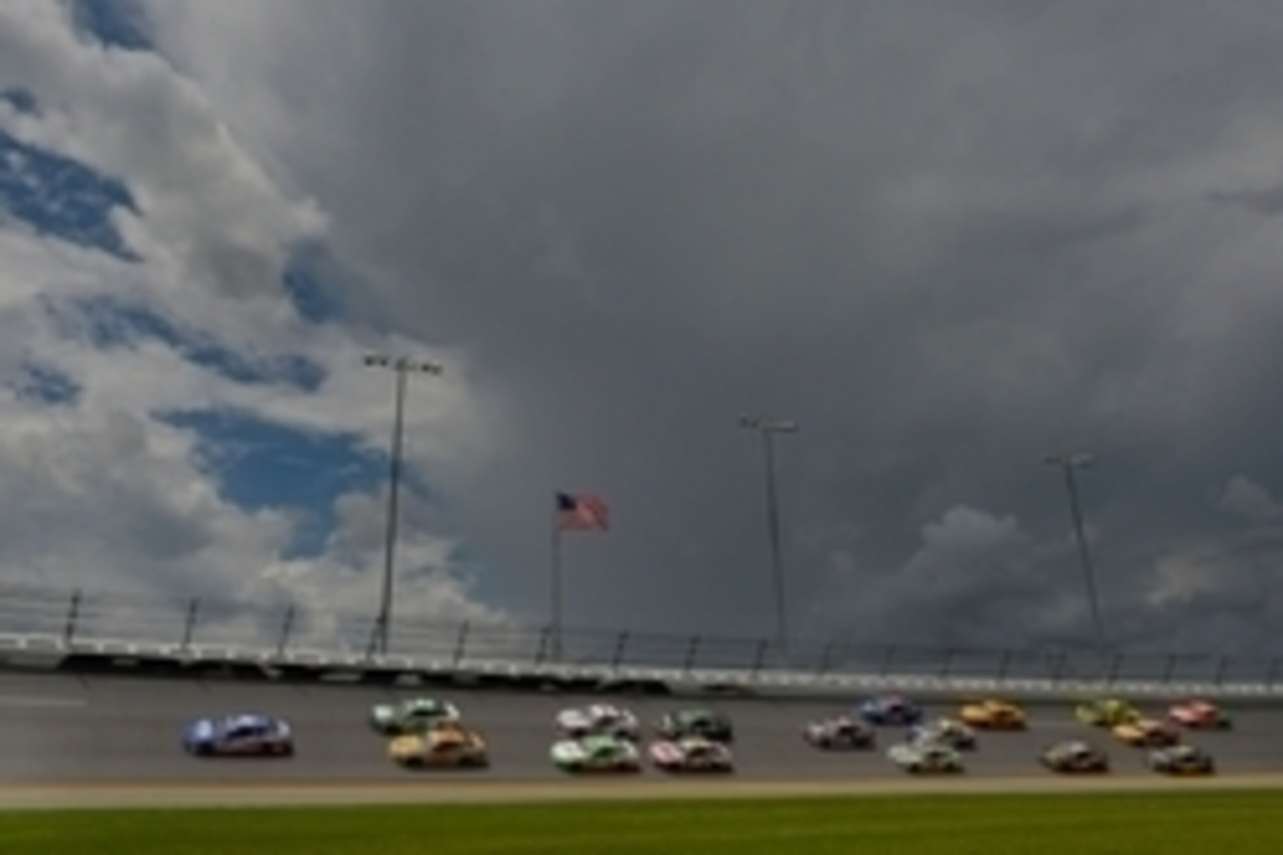 Jul 6, 2014; Daytona Beach, FL, USA; NASCAR Sprint Cup Series driver Reed Sorenson (36) leads a pack of cars as storm clouds roll in during the Coke Zero 400 at Daytona International Speedway. Mandatory Credit: Jasen Vinlove-USA TODAY Sports