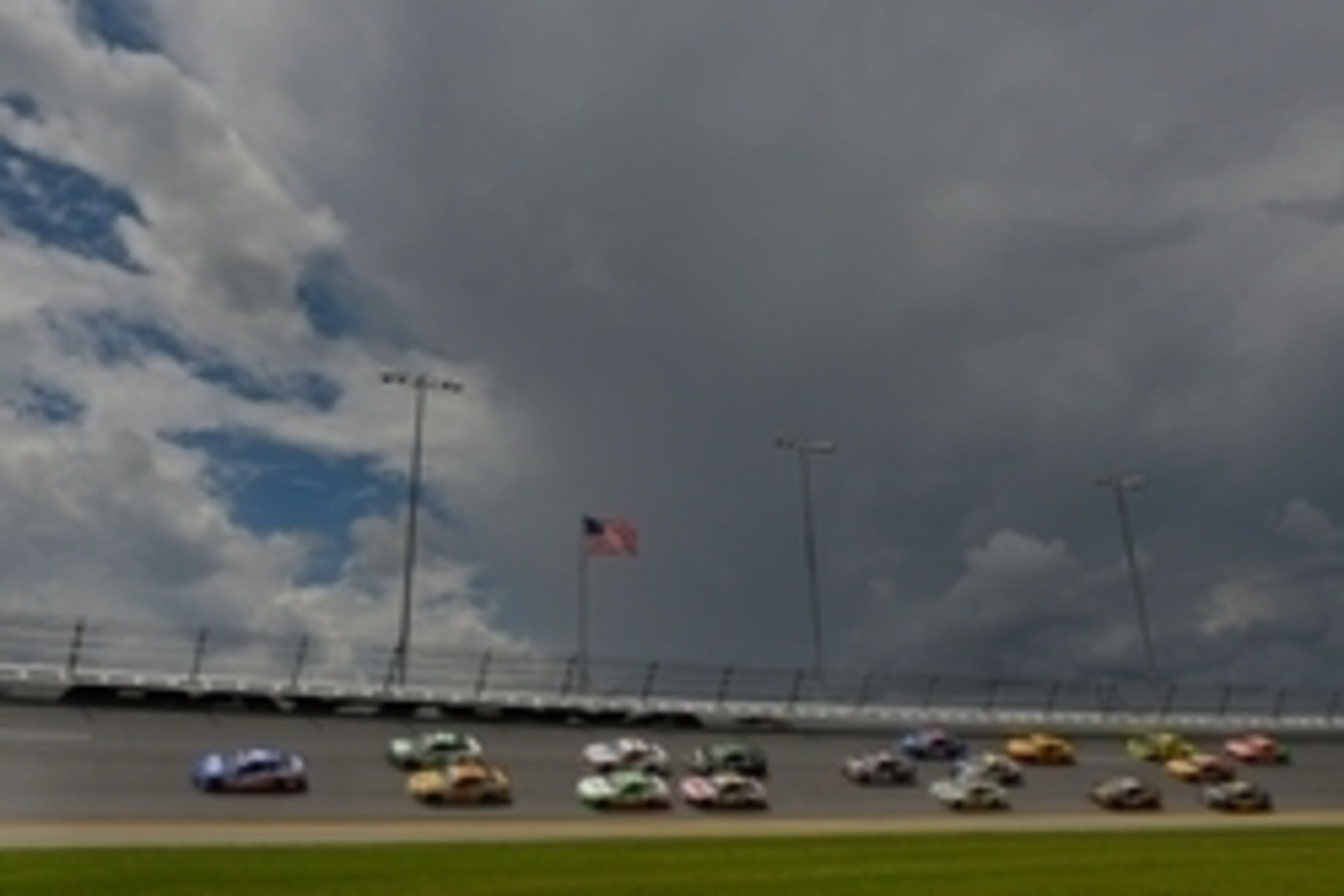 Jul 6, 2014; Daytona Beach, FL, USA; NASCAR Sprint Cup Series driver Reed Sorenson (36) leads a pack of cars as storm clouds roll in during the Coke Zero 400 at Daytona International Speedway. Mandatory Credit: Jasen Vinlove-USA TODAY Sports