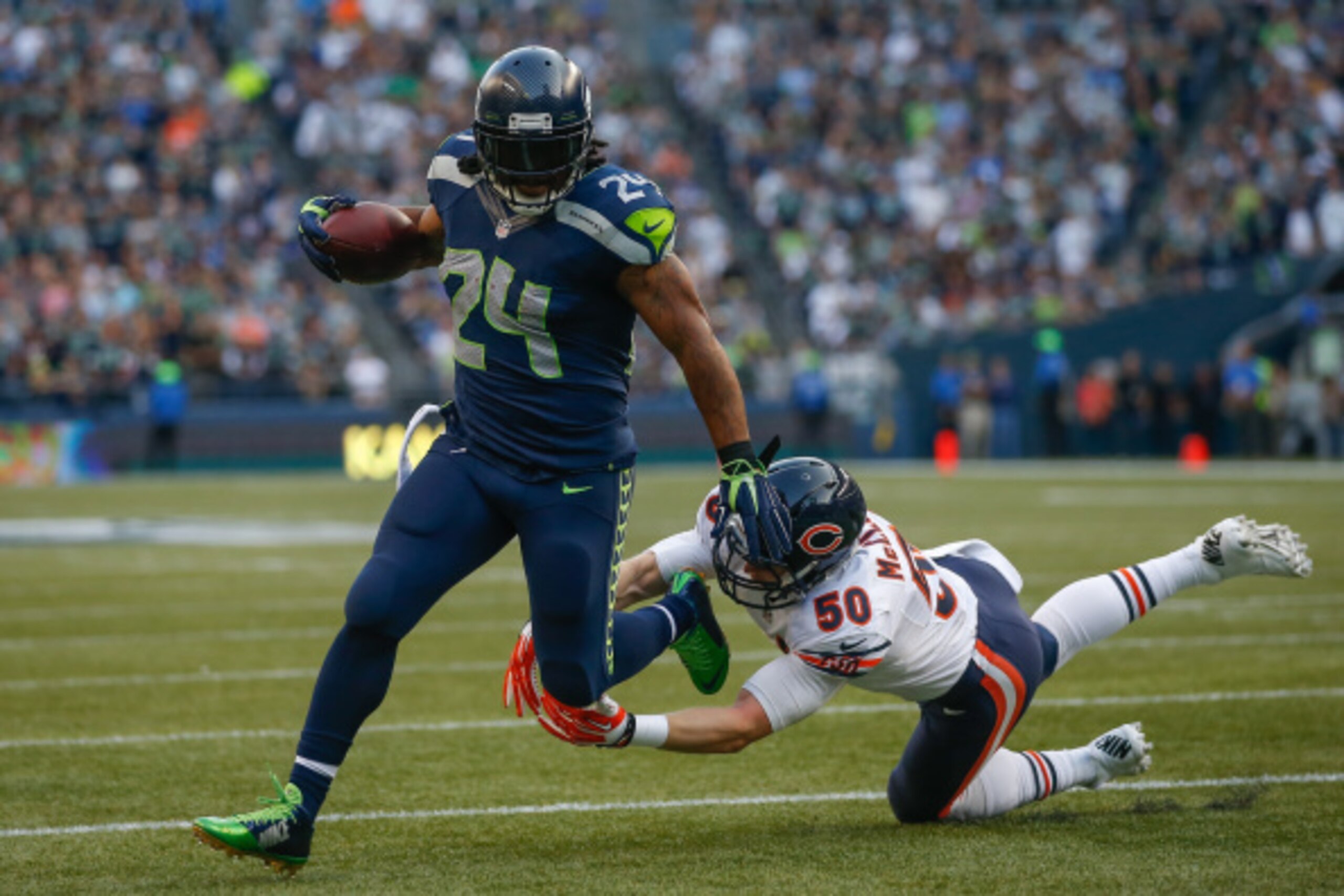 SEATTLE, WA - AUGUST 22:  Running back Marshawn Lynch #24 of the Seattle Seahawks rushes for a touchdown against linebacker Shea McClellin #50 of the Chicago Bears at CenturyLink Field on August 22, 2014 in Seattle, Washington.  (Photo by Otto Greule Jr/G