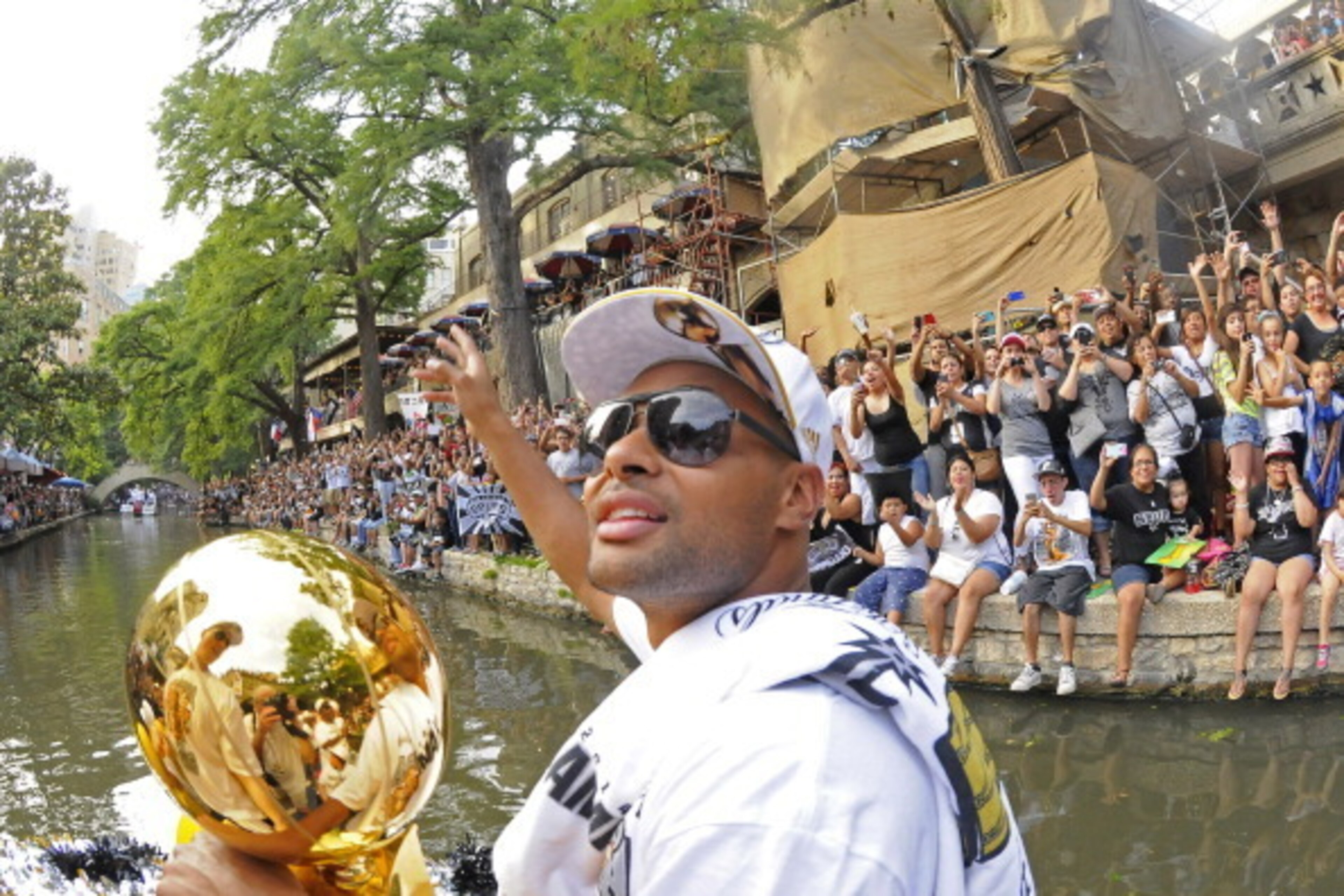 SAN ANTONIO, TX - JUNE 18:  Patty Mills #8 of the San Antonio Spurs waves to the crowd during The San Antonio Spurs NBA Championship Celebration Parade on June 18, 2014 on the San Antonio River in San Antonio, Texas. NOTE TO USER: User expressly acknowled
