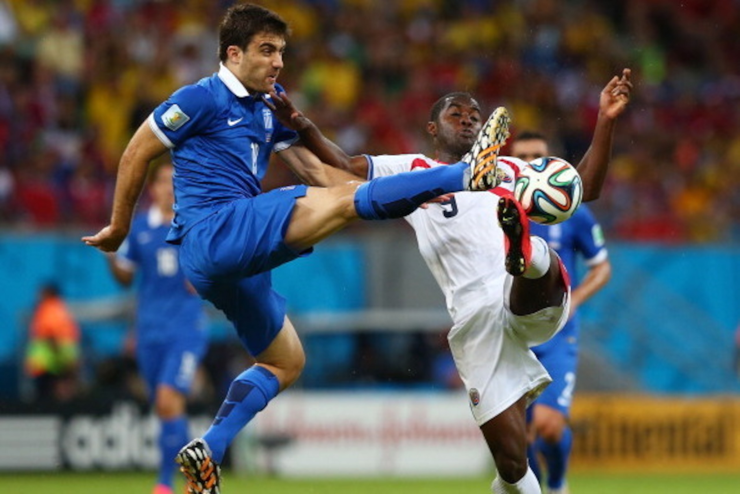 RECIFE, BRAZIL - JUNE 29: Sokratis Papastathopoulos of Greece challenges Joel Campbell of Costa Rica during the 2014 FIFA World Cup Brazil Round of 16 match between Costa Rica and Greece at Arena Pernambuco on June 29, 2014 in Recife, Brazil. (Photo by RECIFE, BRAZIL - JUNE 29: Sokratis Papastathopoulos of Greece challenges Joel Campbell of Costa Rica during the 2014 FIFA World Cup Brazil Round of 16 match between Costa Rica and Greece at Arena Pernambuco on June 29, 2014 in Recife, Brazil. (Photo by