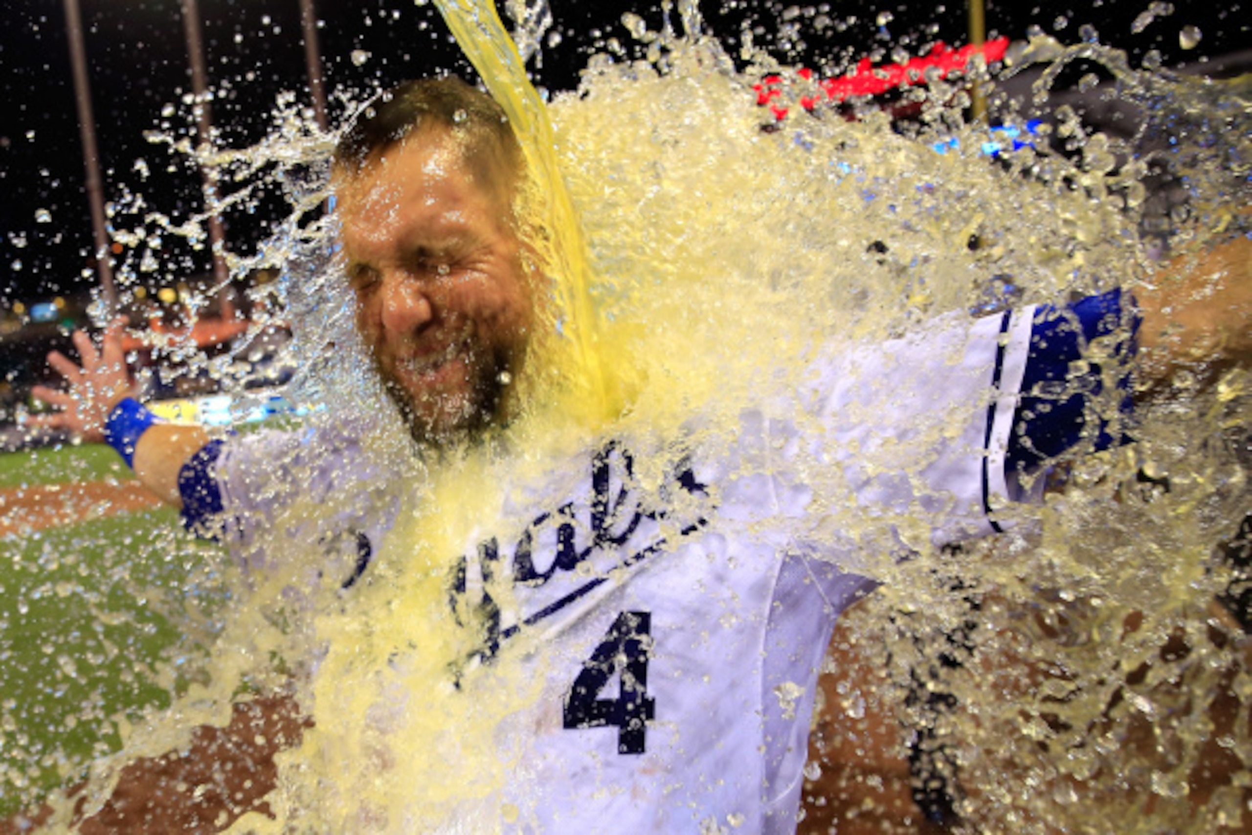 KANSAS CITY, MO - AUGUST 26:  Alex Gordon #4 of the Kansas City Royals is doused with Gatorade by catcher Salvador Perez #13 after hitting a game-winning 2-run home run against the Minnesota Twins in the bottom of the 9th inning to win the game at Kauffma