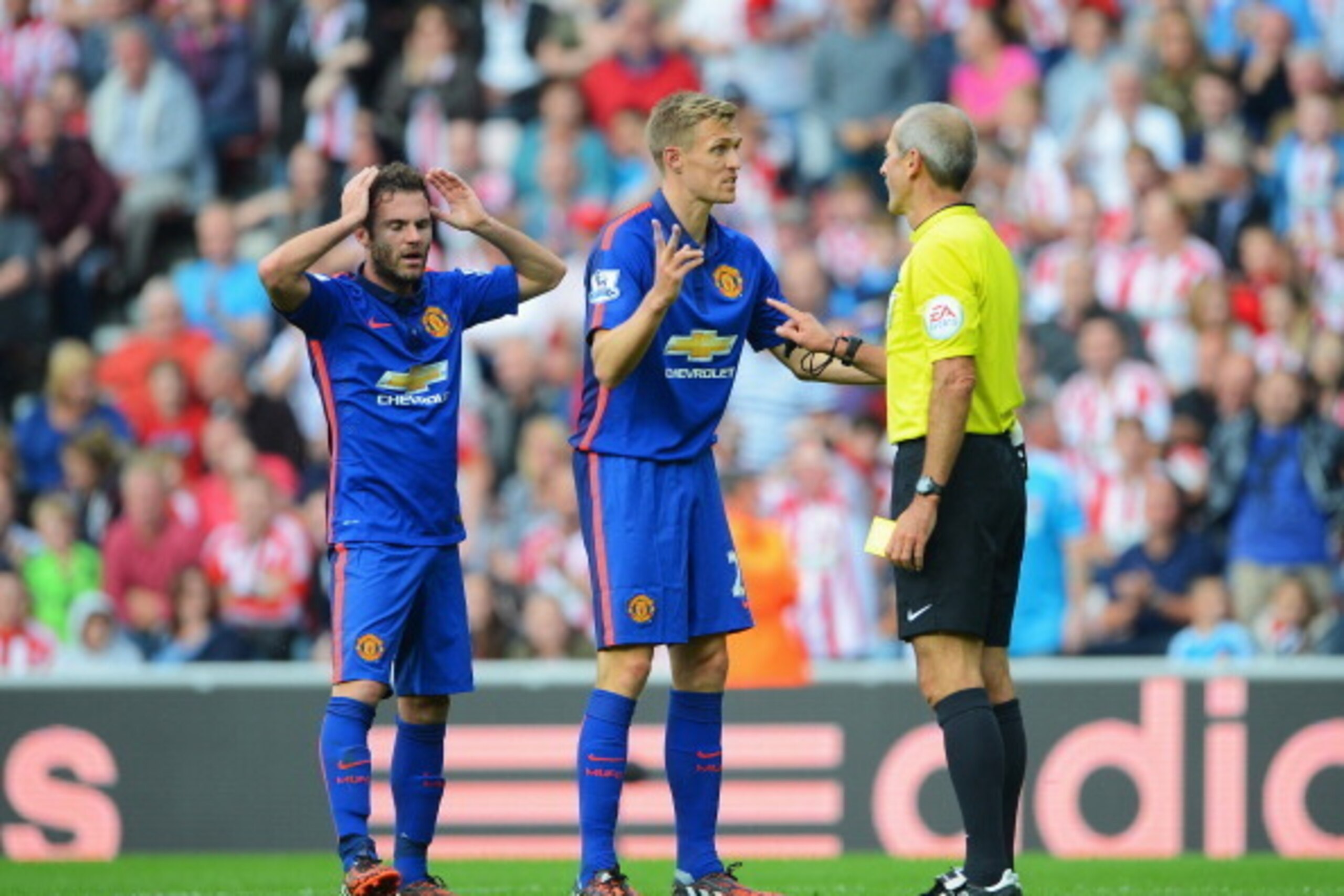 SUNDERLAND, ENGLAND - AUGUST 24: Darren Fletcher and Juan Mata (L) of Manchester United confront referee Martin Atkinson after he booked team mate Ashley Young during the Barclays Premier League match between Sunderland and Manchester United at Stadium of