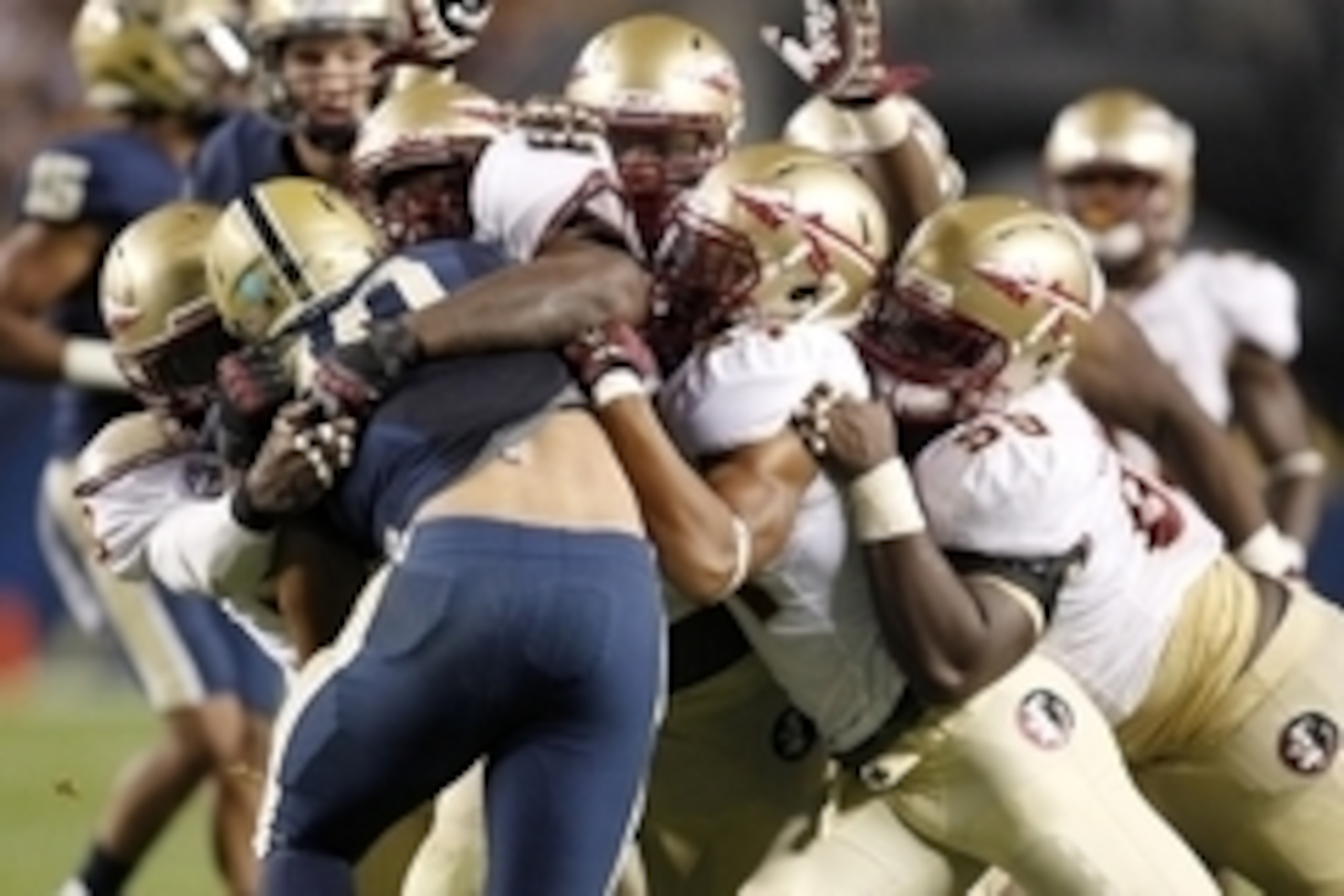 Sep 2, 2013; Pittsburgh, PA, USA; Pittsburgh Panthers running back James Conner (40) tackled by members of the Florida State Seminoles defense during the third quarter at Heinz Field. The Florida State Seminoles won 41-13. Mandatory Credit: Charles LeClai