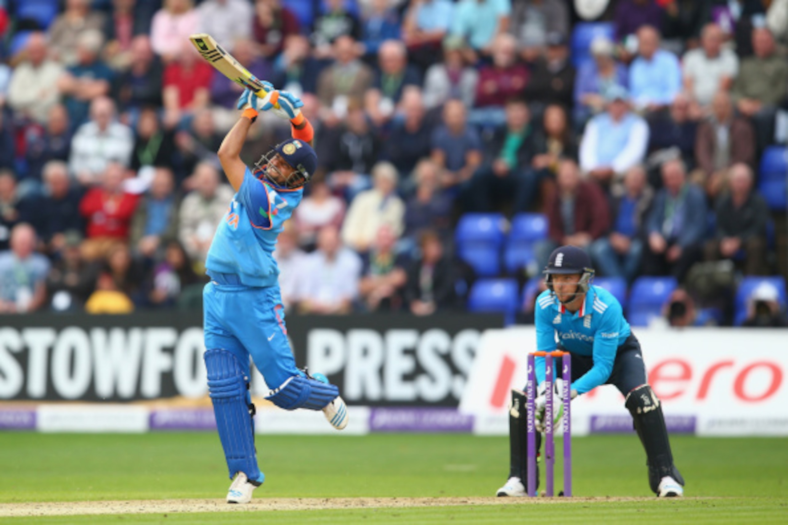 CARDIFF, WALES - AUGUST 27:  Suresh Raina of India hits a straight six off the bowling of James Tredwell as wicketkeeper Jos Buttler looks on during the second Royal London One-Day Series match between England and India at the SWALEC Stadium on August 27,