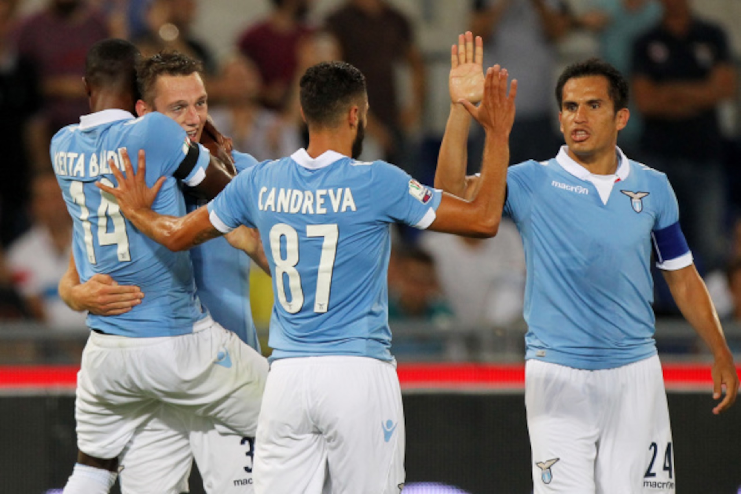 ROME, ITALY - AUGUST 24:  Stefan De Vrij (2nd- L) with his teammates of SS Lazio celebrates after scoring the second team's goal during the TIM Cup match between SS Lazio and Bassano FC at Olimpico Stadium on August 24, 2014 in Rome, Italy.  (Photo by Pao