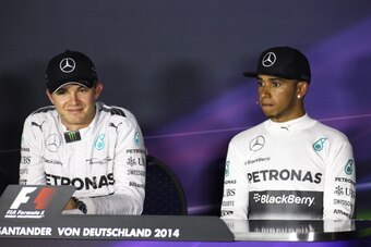 HOCKENHEIM, GERMANY - JULY 20:  Nico Rosberg of Germany and Mercedes GP smiles next to Lewis Hamilton of Great Britain and Mercedes GP during the drivers' press conference after victory in the German Grand Prix at Hockenheimring on July 20, 2014 in Hocken