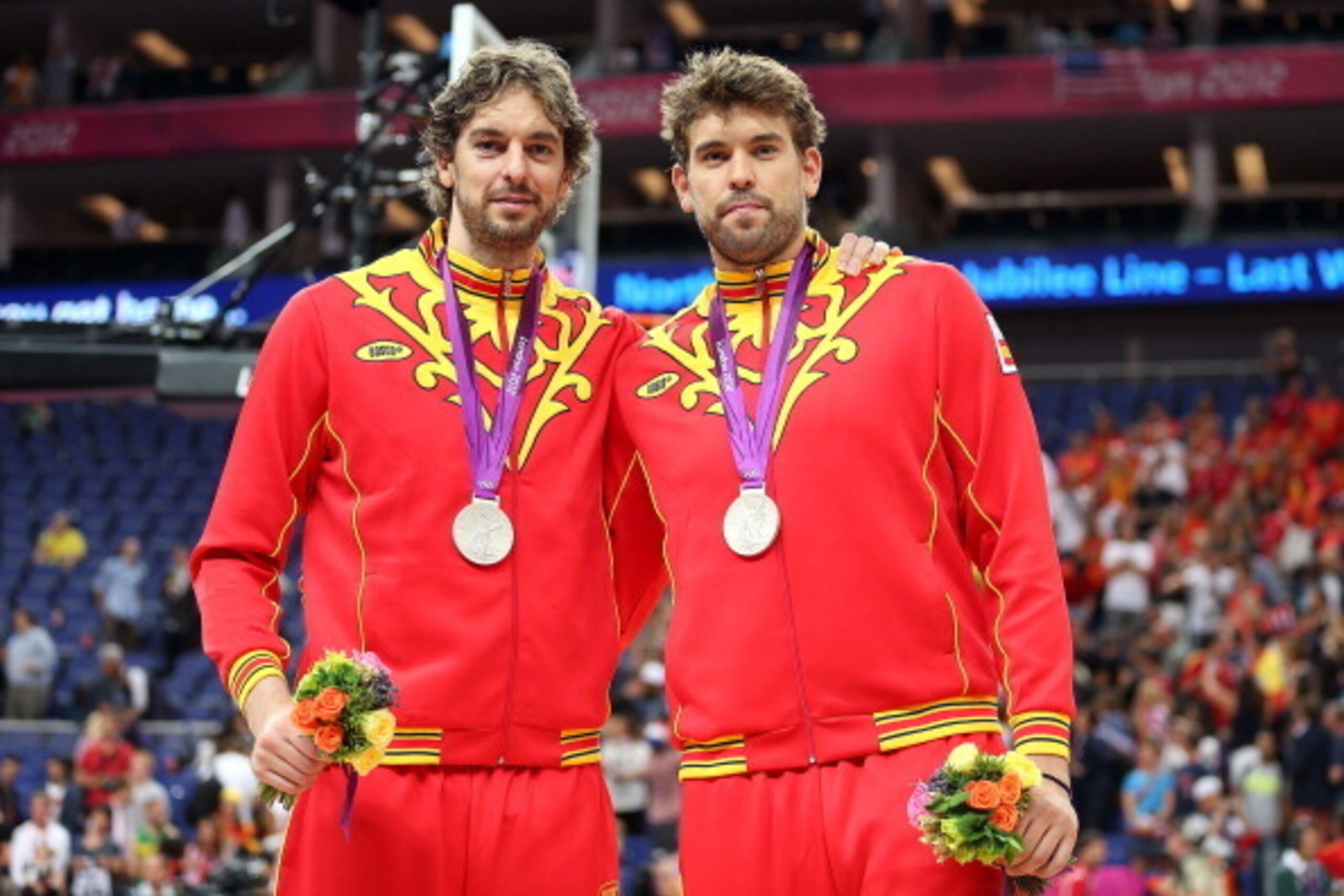 LONDON, ENGLAND - AUGUST 12:  Silver medallist Pau Gasol #4 of Spain and Marc Gasol #13 of Spain pose on the podium during the medal ceremony for the Men's Basketball on Day 16 of the London 2012 Olympics Games at North Greenwich Arena on August 12, 2012 