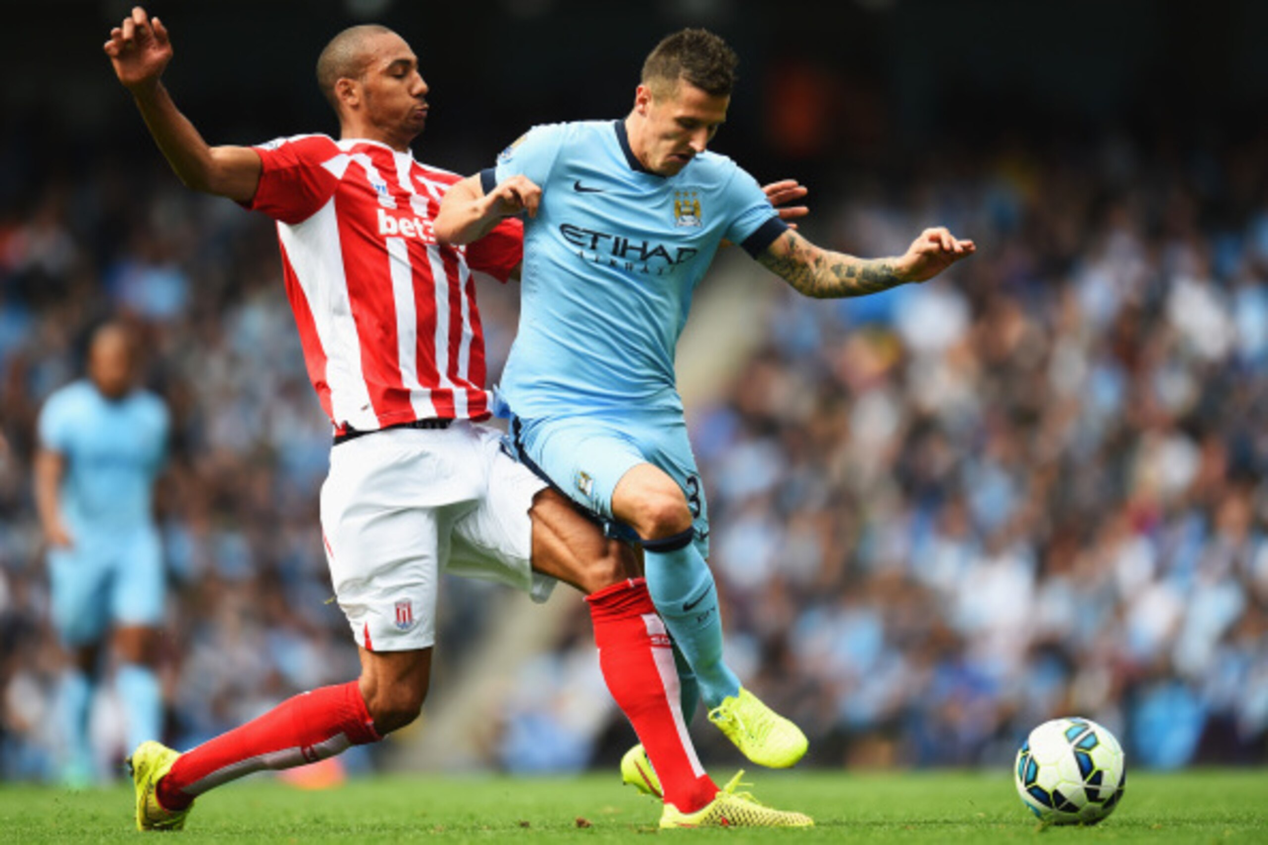 MANCHESTER, ENGLAND - AUGUST 30: Stevan Jovetic of Manchester City is tackled by Steven N'Zonzi of Stoke City during the Barclays Premier League match between Manchester City and Stoke City at Etihad Stadium on August 30, 2014 in Manchester, England.  (Ph