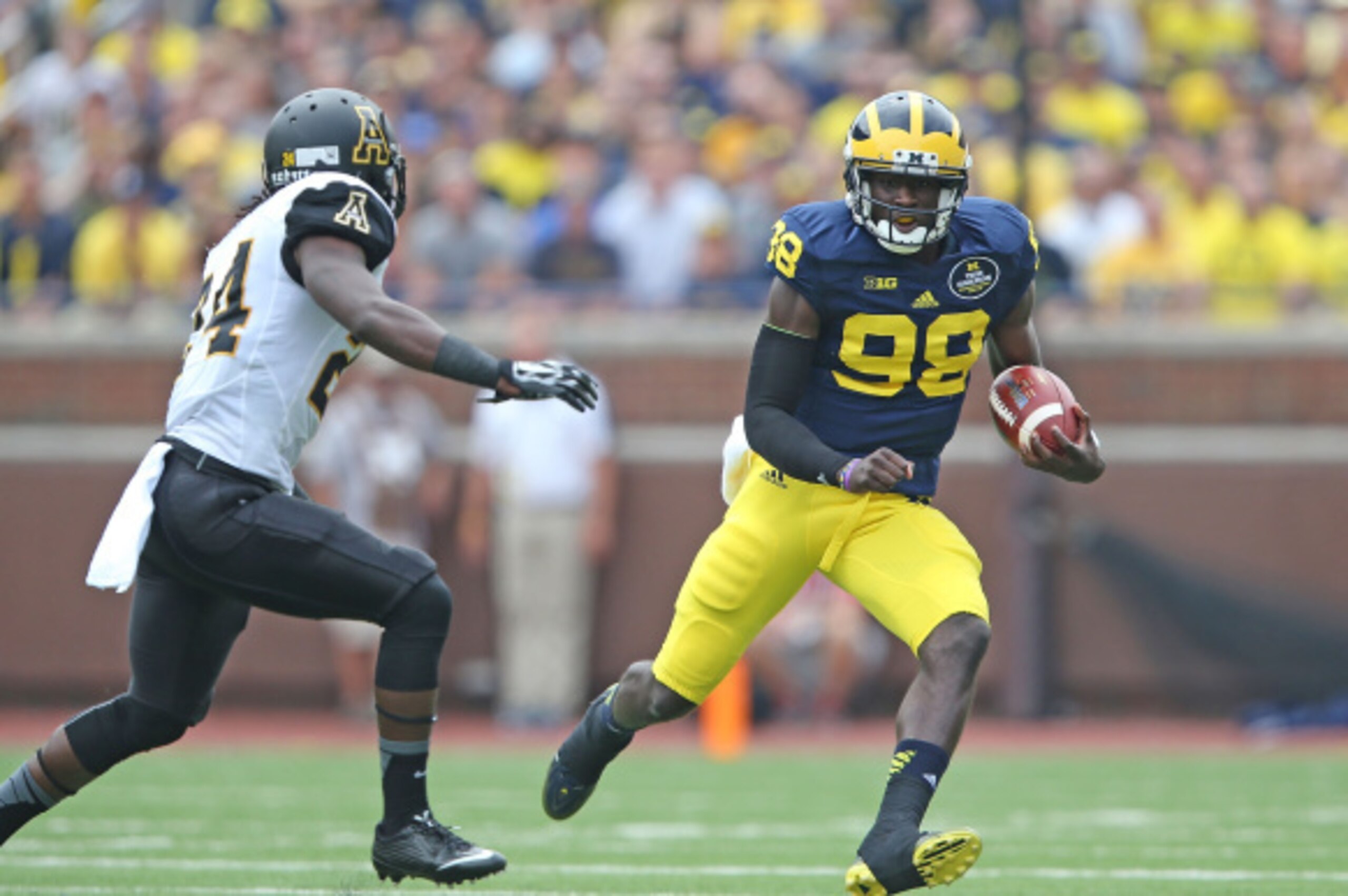 ANN ARBOR, MI - AUGUST 30: Michigan Wolverines quarterback Devin Gardner #98 runs for a first down during the first half of the game against Appalachian State at Michigan Stadium on August 30, 2014 in Ann Arbor, Michigan.  (Photo by Leon Halip/Getty Image
