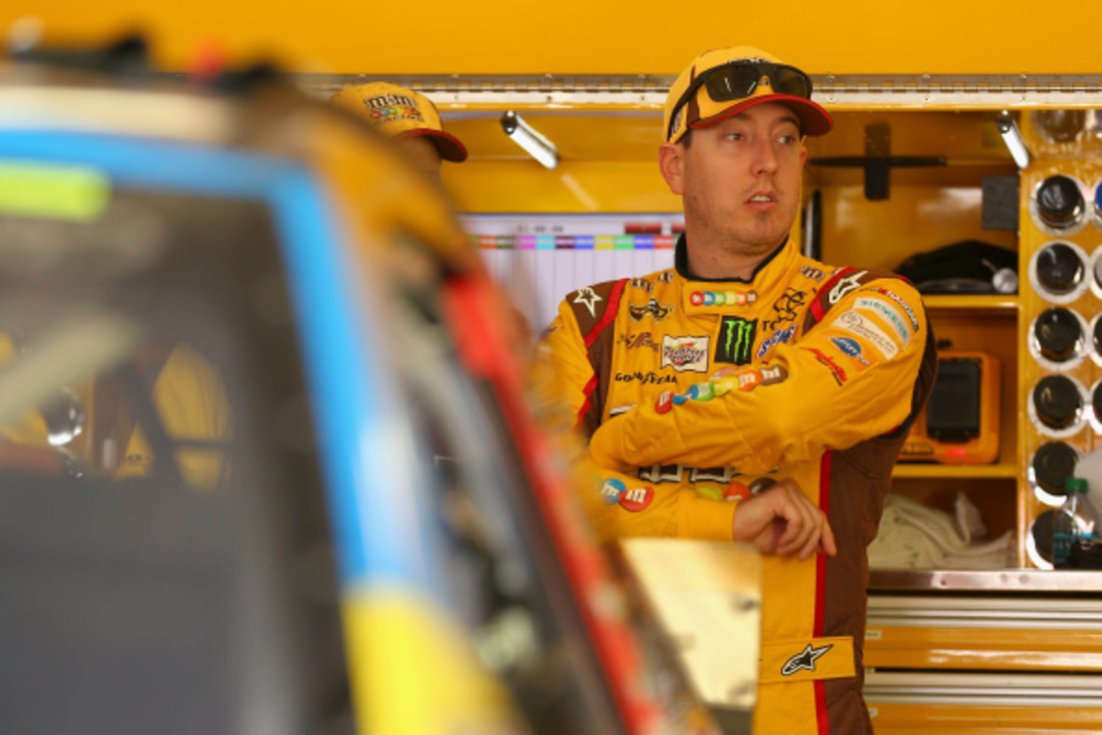 HAMPTON, GA - AUGUST 29:  Kyle Busch, driver of the #18 M&M's Toyota, stands in the garage area during practice for the NASCAR Sprint Cup Series Oral-B USA 500 at Atlanta Motor Speedway on August 29, 2014 in Hampton, Georgia.  (Photo by Mike Ehrmann/Getty