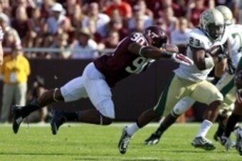 Aug 30, 2014; Blacksburg, VA, USA; William & Mary Tribe running back Kendell Anderson (23) is tackles by Virginia Tech Hokies defensive end Dadi Nicolas (90) during the second quarter at Lane Stadium. Mandatory Credit: Peter Casey-USA TODAY Sports
