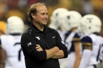 Aug 30, 2014; Atlanta, GA, USA; West Virginia Mountaineers head coach Dana Holgorsen looks on during warmups prior to the 2014 Chick-fil-a kickoff game against the Alabama Crimson Tide at Georgia Dome. Mandatory Credit: Paul Abell-USA TODAY Sports