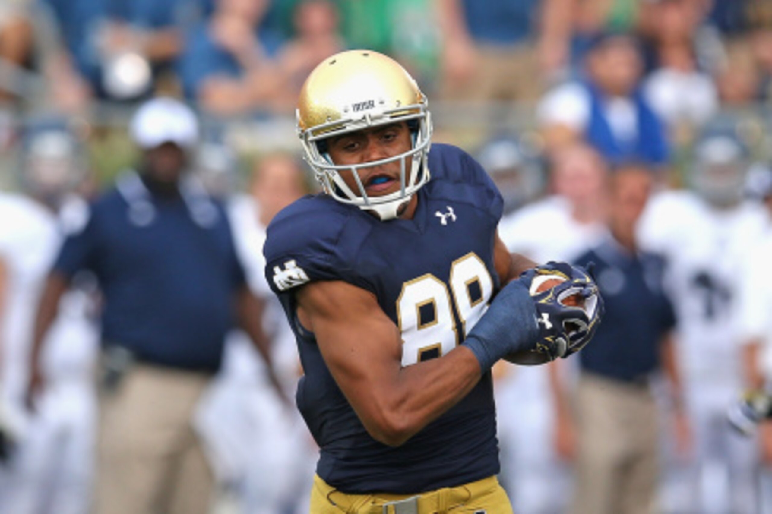 SOUTH BEND, IN - AUGUST 30:  Corey Robinson #88 of the Notre Dame Fighting Irish is tackled by Ryan Pollard #22 of the Rice Owls after a first down catch at Notre Dame Stadium on August 30, 2014 in South Bend, Indiana.  (Photo by Jonathan Daniel/Getty Ima