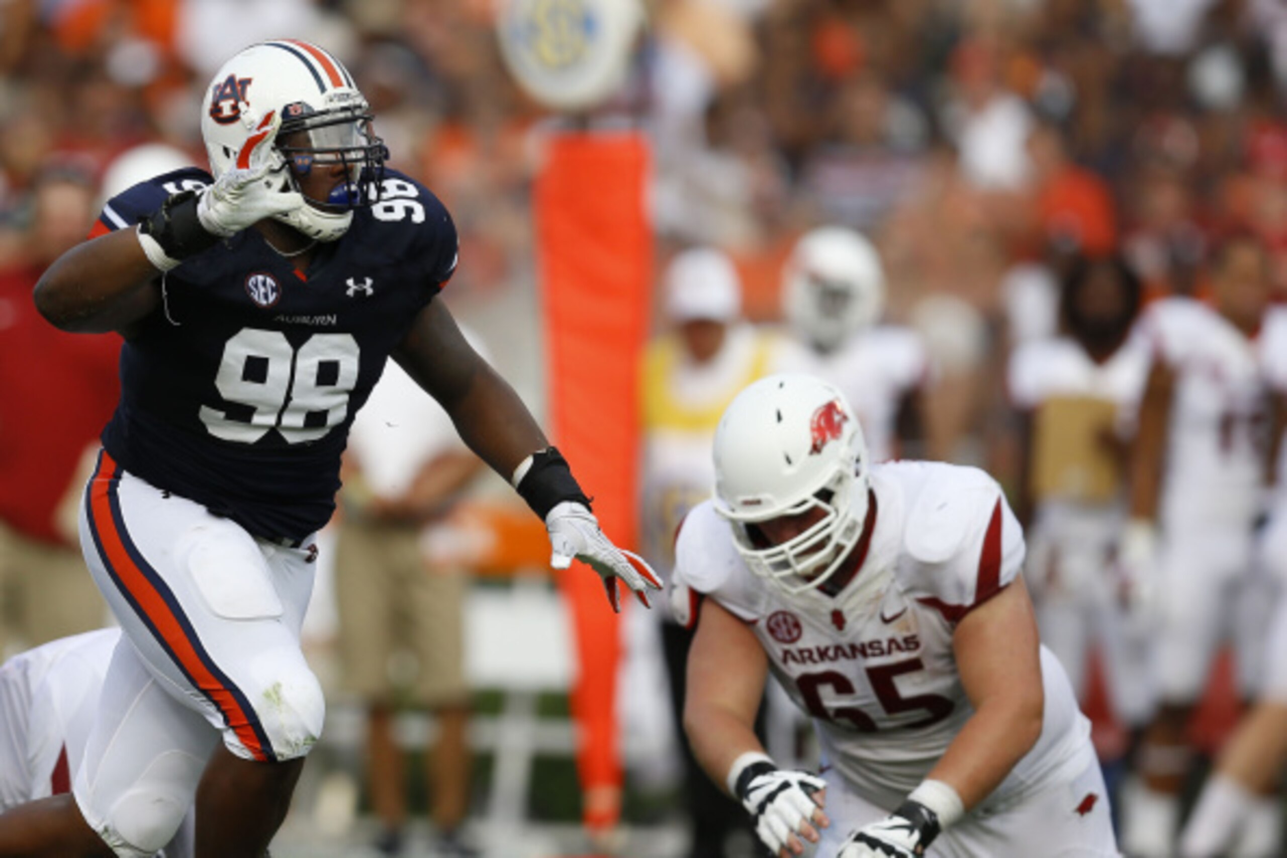 AUBURN, AL - AUGUST 30:  Defensive lineman Angelo Blackson #98 of the Auburn Tigers celebrates a sack while offensive guard Mitch Smothers #65 of the Arkansas Razorbacks falls to the ground during the game at Jordan Hare Stadium on August 30, 2014 in Aubu