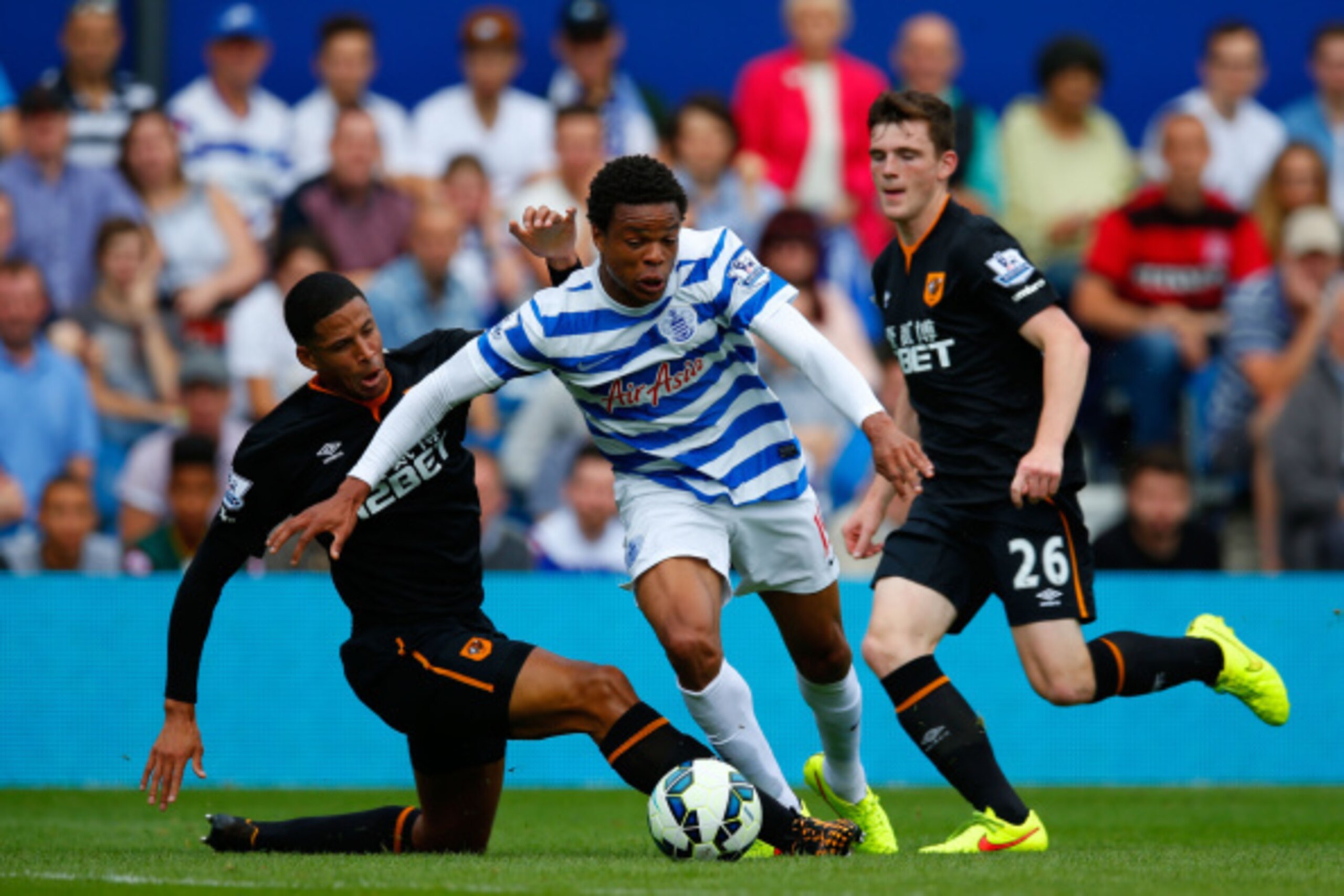 LONDON, ENGLAND - AUGUST 16:  Curtis Davies of Hull City slides in to tackle Loic Remy of Queens Park Rangers during the Barclays Premier League match between Queens Park Rangers and Hull City at Loftus Road on August 16, 2014 in London, England.  (Photo 