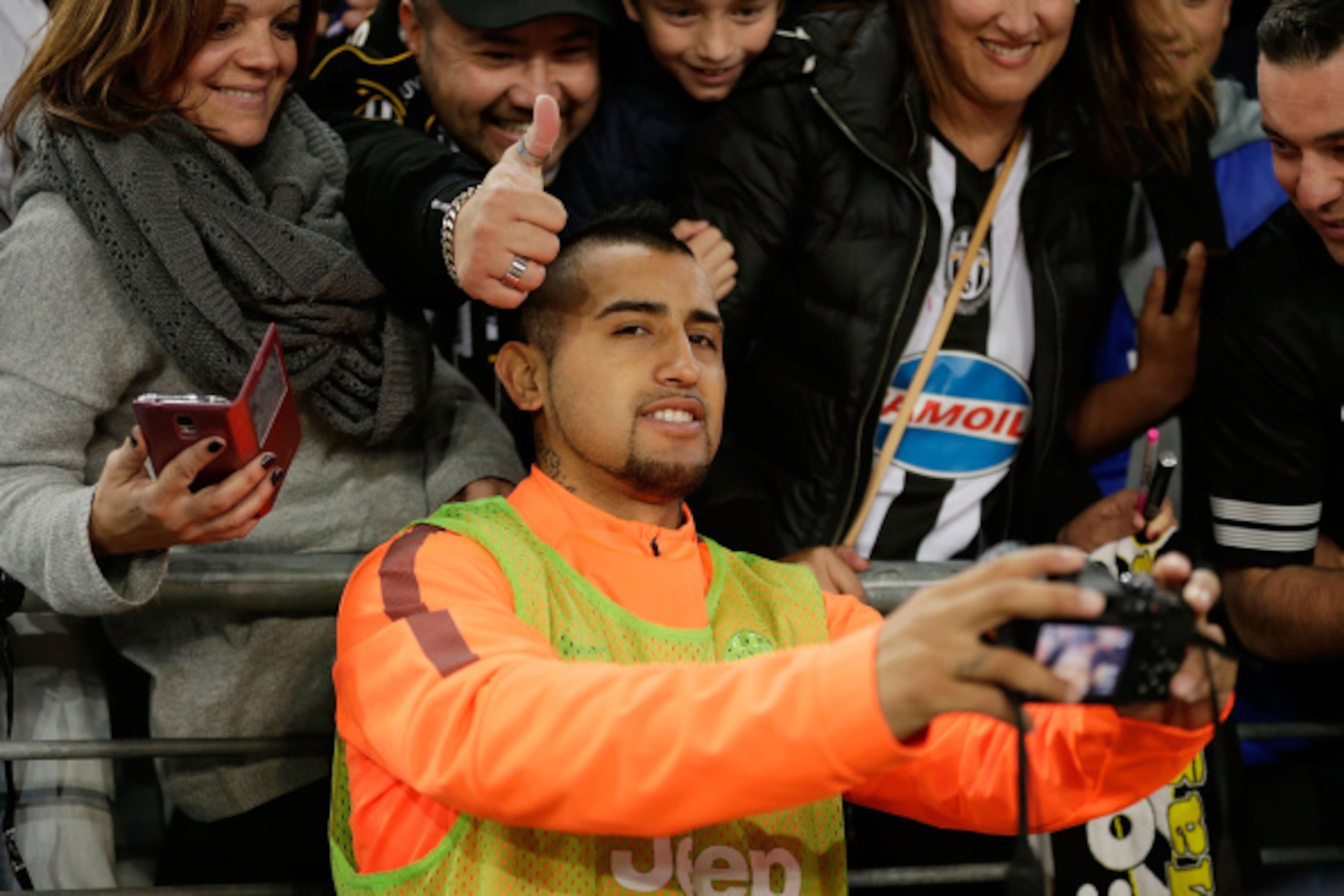 SYDNEY, AUSTRALIA - AUGUST 10:  Arturo Vidal of Juventus takes a photo with fans after the match between the A-League All Stars and Juventus at ANZ Stadium on August 10, 2014 in Sydney, Australia.  (Photo by Mark Metcalfe/Getty Images)