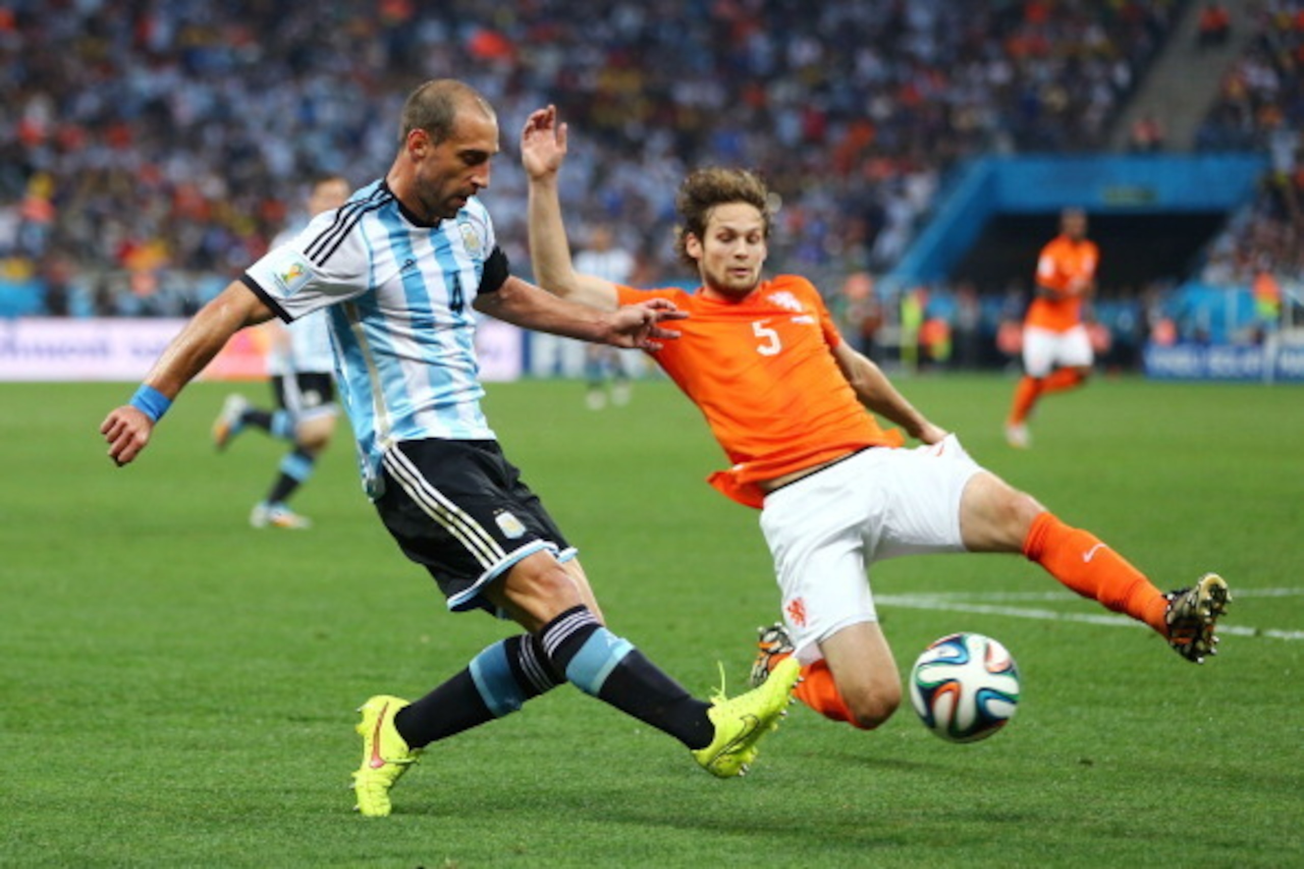 SAO PAULO, BRAZIL - JULY 09: Pablo Zabaleta of Argentina is challenged by Daley Blind of the Netherlands during the 2014 FIFA World Cup Brazil Semi Final match between the Netherlands and Argentina at Arena de Sao Paulo on July 9, 2014 in Sao Paulo, Brazi