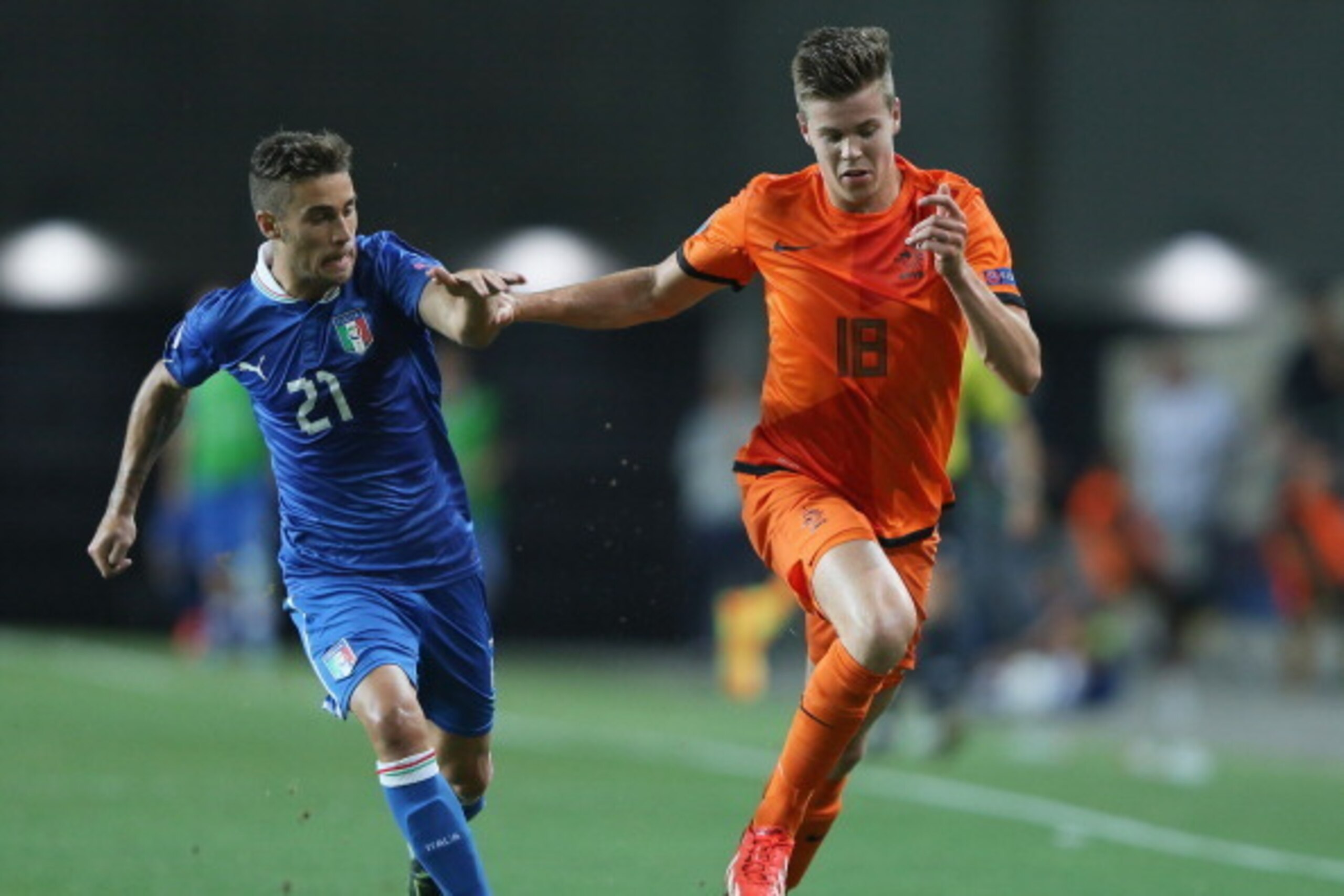 PETAH TIQWA, ISRAEL - JUNE 15:  Fausto Rossi of Italy tries to tackle Marco Van Ginkel of the Netherlands during the UEFA European U21 Championships semi- final match between Italy and the Netherlands at Ha Moshava Stadium on June 15, 2013 in Petah Tiqwa,