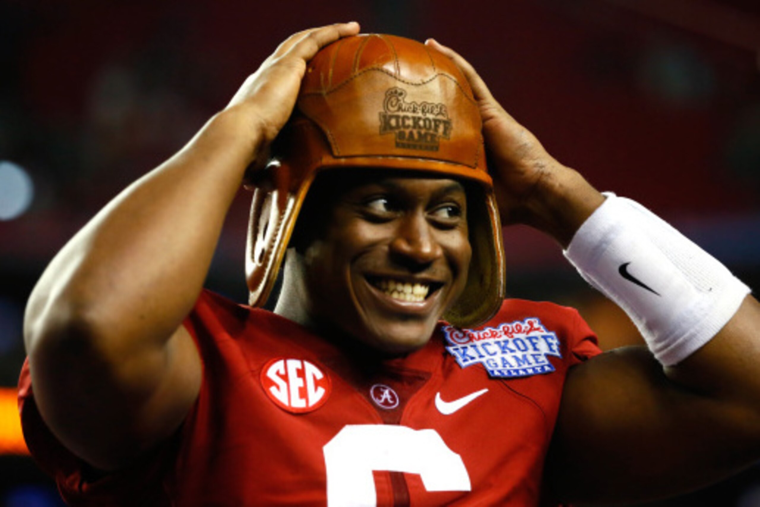 ATLANTA, GA - AUGUST 30:  Blake Sims #6 of the Alabama Crimson Tide wears the old leather helmet trophy after their 33-23 win over the West Virginia Mountaineers at Georgia Dome on August 30, 2014 in Atlanta, Georgia.  (Photo by Kevin C. Cox/Getty Images)