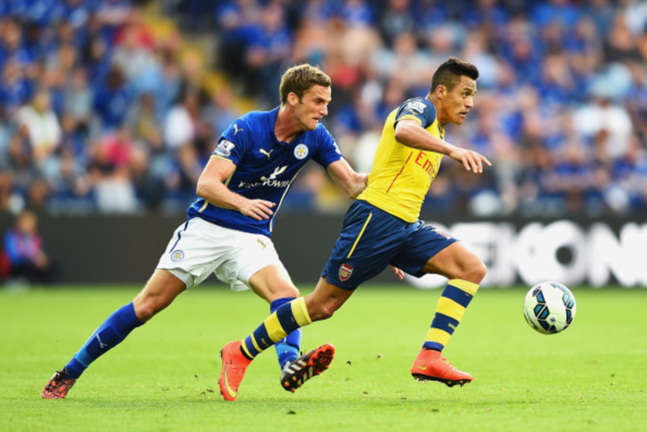 LEICESTER, ENGLAND - AUGUST 31:  Alexis Sanchez of Arsenal goes past Andy King of Leicester City during the Barclays Premier League match between Leicester City and Arsenal at The King Power Stadium on August 31, 2014 in Leicester, England.  (Photo by Lau