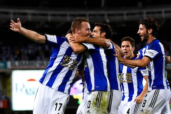 SAN SEBASTIAN, SPAIN - AUGUST 31:  David Zurutuza Veillet (L) of Real Sociedad celebrates with his teammates  after scoring his team's third goal during the La Liga match between Real Sociedad de Futbol and Real Madrid CF at Estadio Anoeta on August 31, 2