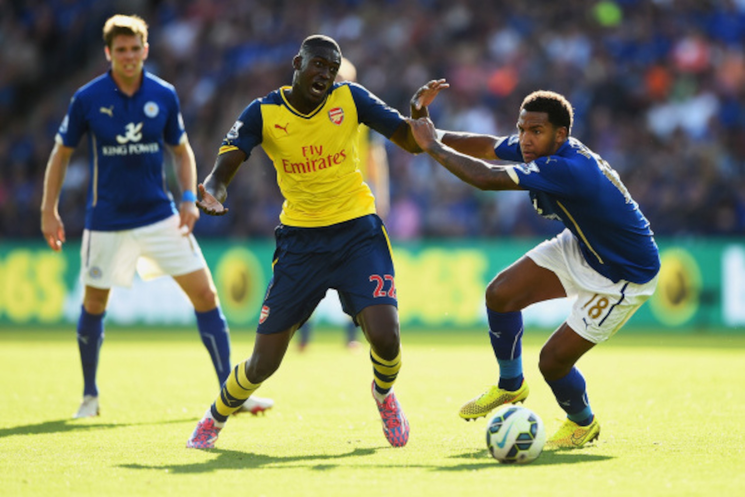 LEICESTER, ENGLAND - AUGUST 31: Yaya Sanogo of Arsenal is challenged by Liam Moore of Leicester City during the Barclays Premier League match between Leicester City and Arsenal at The King Power Stadium on August 31, 2014 in Leicester, England.  (Photo by