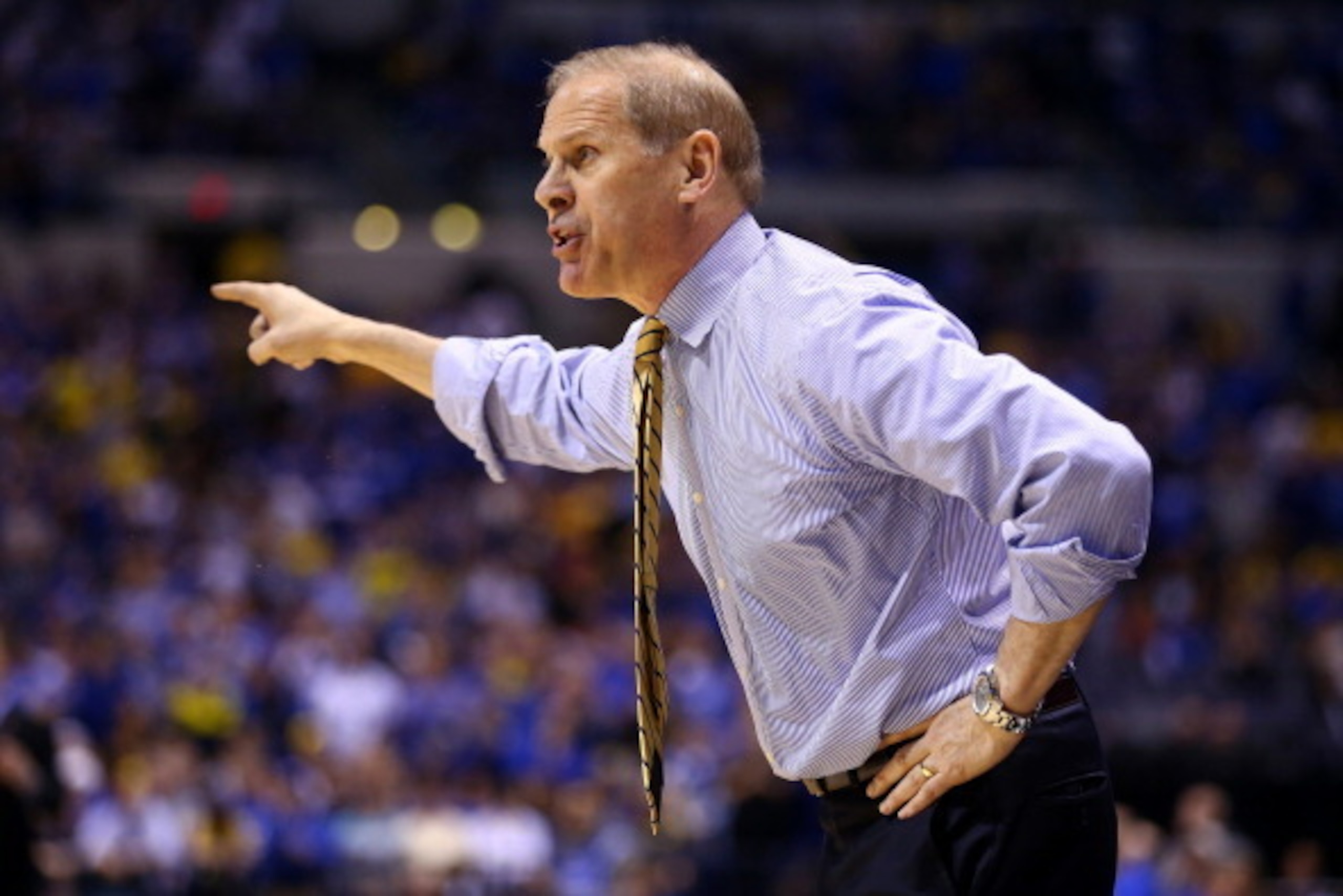 INDIANAPOLIS, IN - MARCH 30: Head coach John Beilein of the Michigan Wolverines shouts to his players against the Kentucky Wildcats during the midwest regional final of the 2014 NCAA Men's Basketball Tournament at Lucas Oil Stadium on March 30, 2014 in I INDIANAPOLIS, IN - MARCH 30: Head coach John Beilein of the Michigan Wolverines shouts to his players against the Kentucky Wildcats during the midwest regional final of the 2014 NCAA Men's Basketball Tournament at Lucas Oil Stadium on March 30, 2014 in I