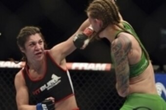 Apr 26, 2014; Baltimore, MD, USA;  Bethe Correia (left) lands a head shot on Jessamyn Duke during the second round  in UFC 172 at Baltimore Arena. Correia defeated Duke by judges decision.  Mandatory Credit: Tommy Gilligan-USA TODAY Sports