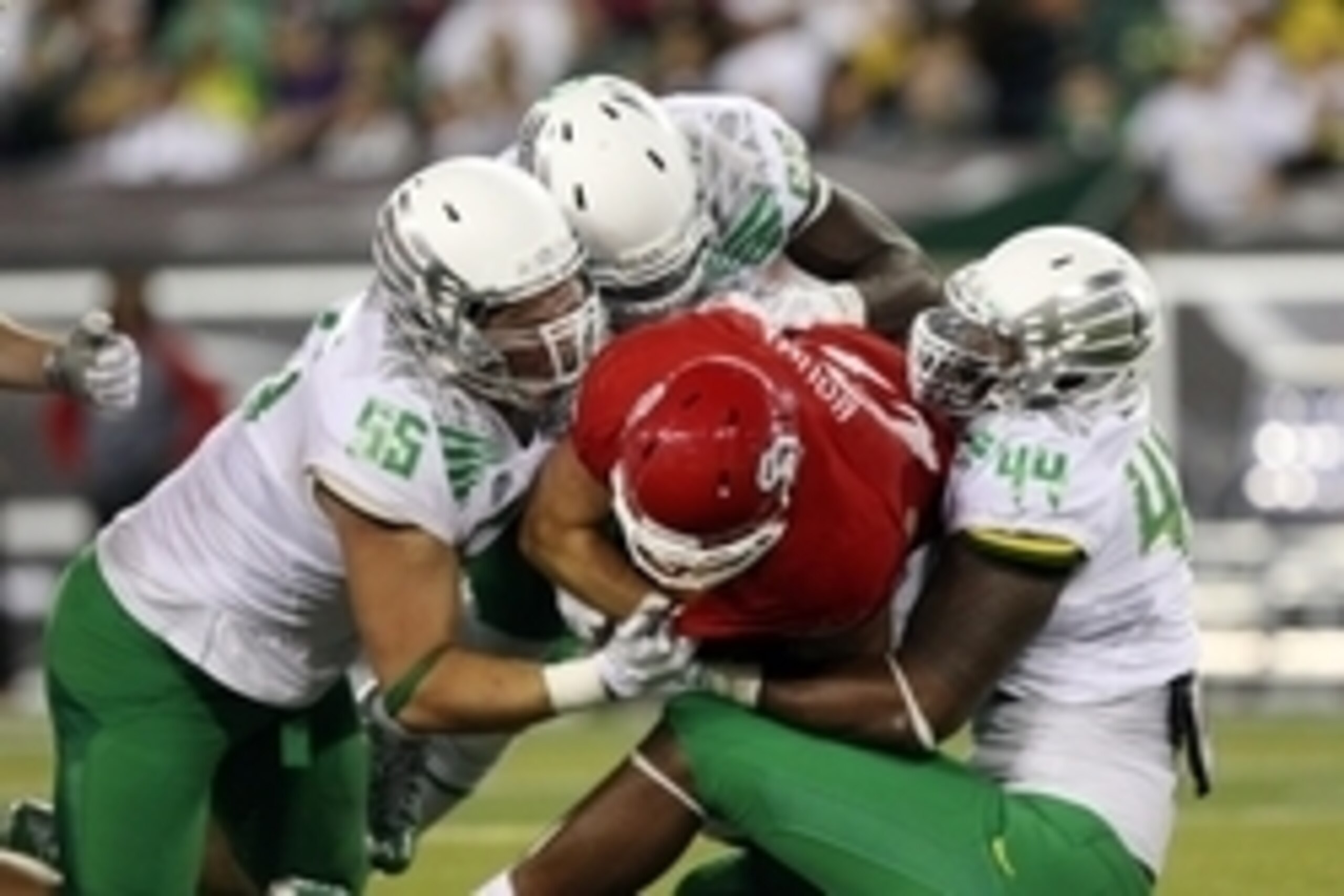 Aug 30, 2014; Eugene, OR, USA; Oregon Ducks defensive lineman Alex Balducci (56), linebacker Torrodney Prevot (86) and defensive lineman DeForest Buckner (44) tackle South Dakota Coyotes running back Trevor Bouma (21) at Autzen Stadium. Mandatory Credit: 