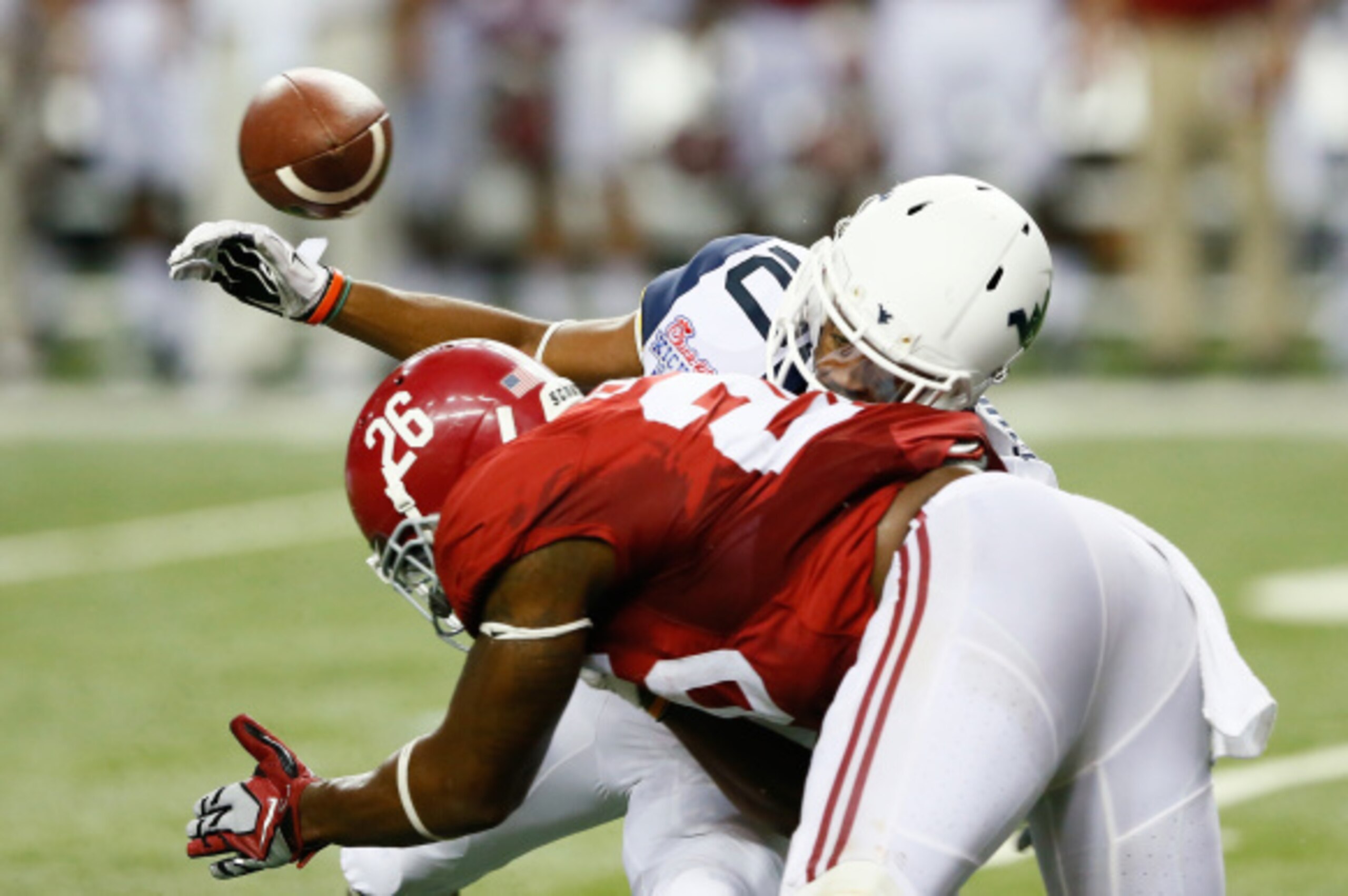 ATLANTA, GA - AUGUST 30:  Jordan Thompson #10 of the West Virginia Mountaineers fails to pull in this reception as he is hit by Landon Collins #26 of the Alabama Crimson Tide at Georgia Dome on August 30, 2014 in Atlanta, Georgia.  (Photo by Kevin C. Cox/