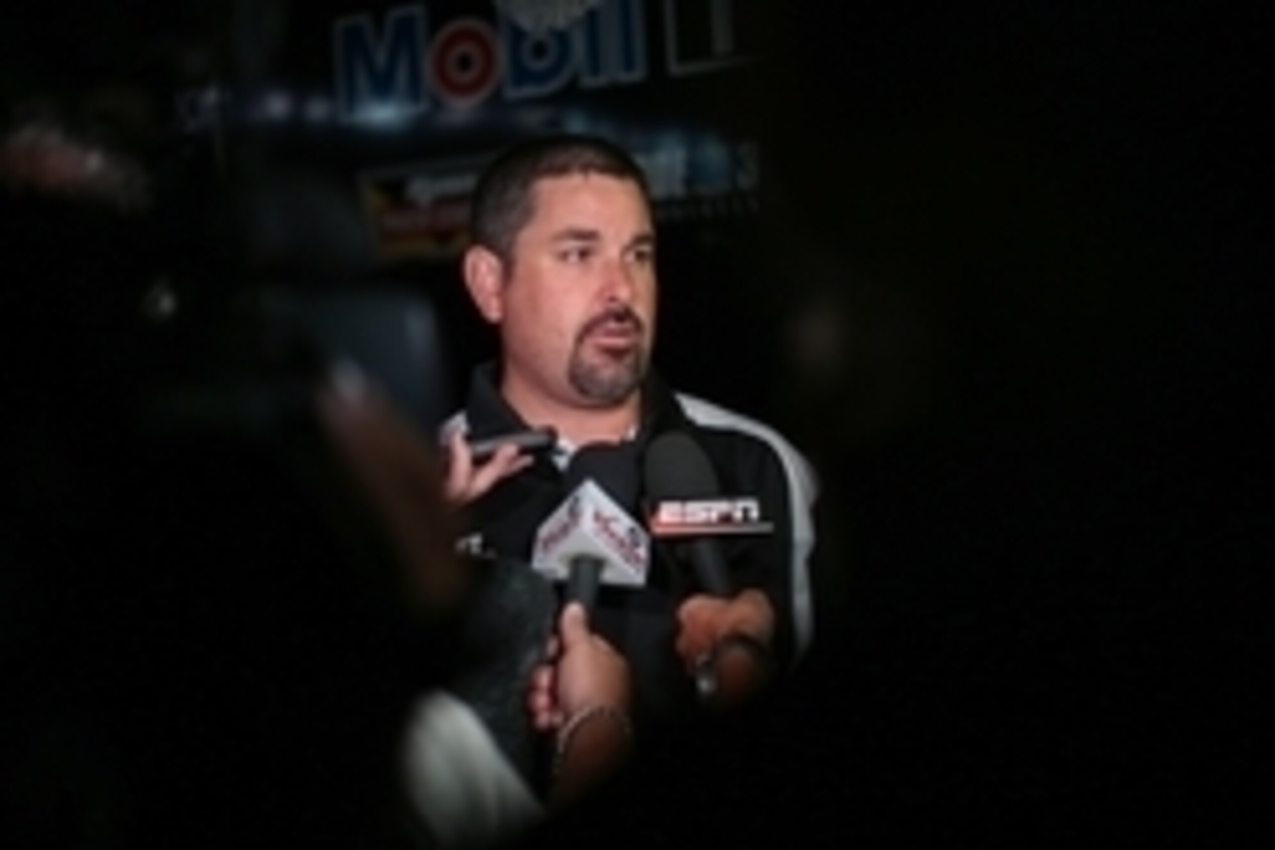 Aug 31, 2014; Hampton, GA, USA; Mike Arning a spokesman for True Speed Communication speaks on behalf of Sprint Cup Series driver Tony Stewart (14) after Stewart hit the wall during the Oral-B USA 500 and left the race early at Atlanta Motor Speedway. Man