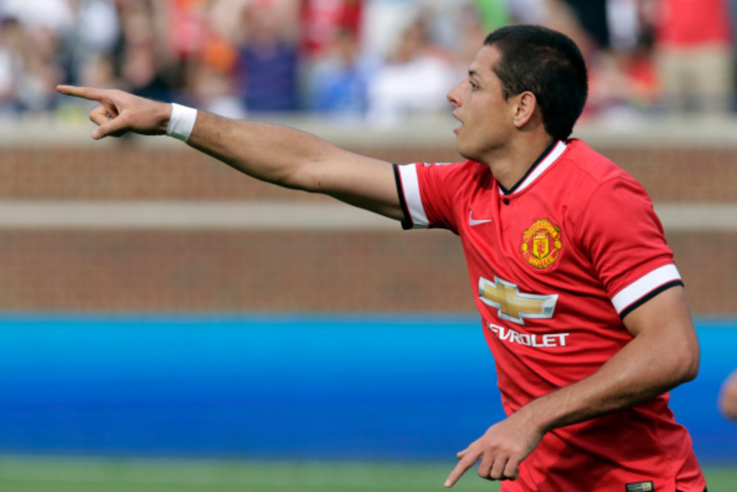 ANN ARBOR, MI - AUGUST 2:  Javier Hernandez #14 of Manchester United points to Shinji Kagawa, who passed him the ball for a goal, during the second half of the Guinness International Champions Cup at Michigan Stadium on August 2, 2014, in Ann Arbor, Mich.