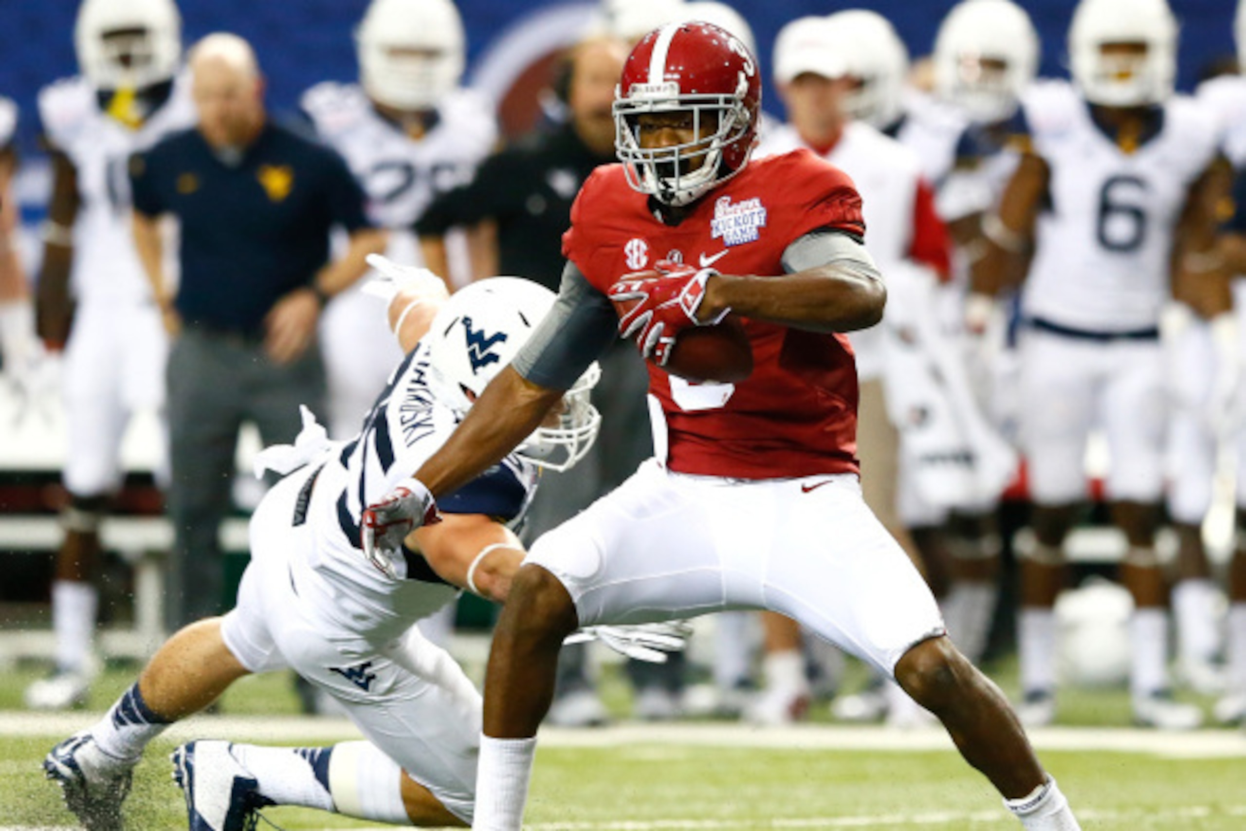 ATLANTA, GA - AUGUST 30:  Amari Cooper #9 of the Alabama Crimson Tide breaks a tackle by Nick Kwiatkoski #35 of the West Virginia Mountaineers at Georgia Dome on August 30, 2014 in Atlanta, Georgia.  (Photo by Kevin C. Cox/Getty Images)