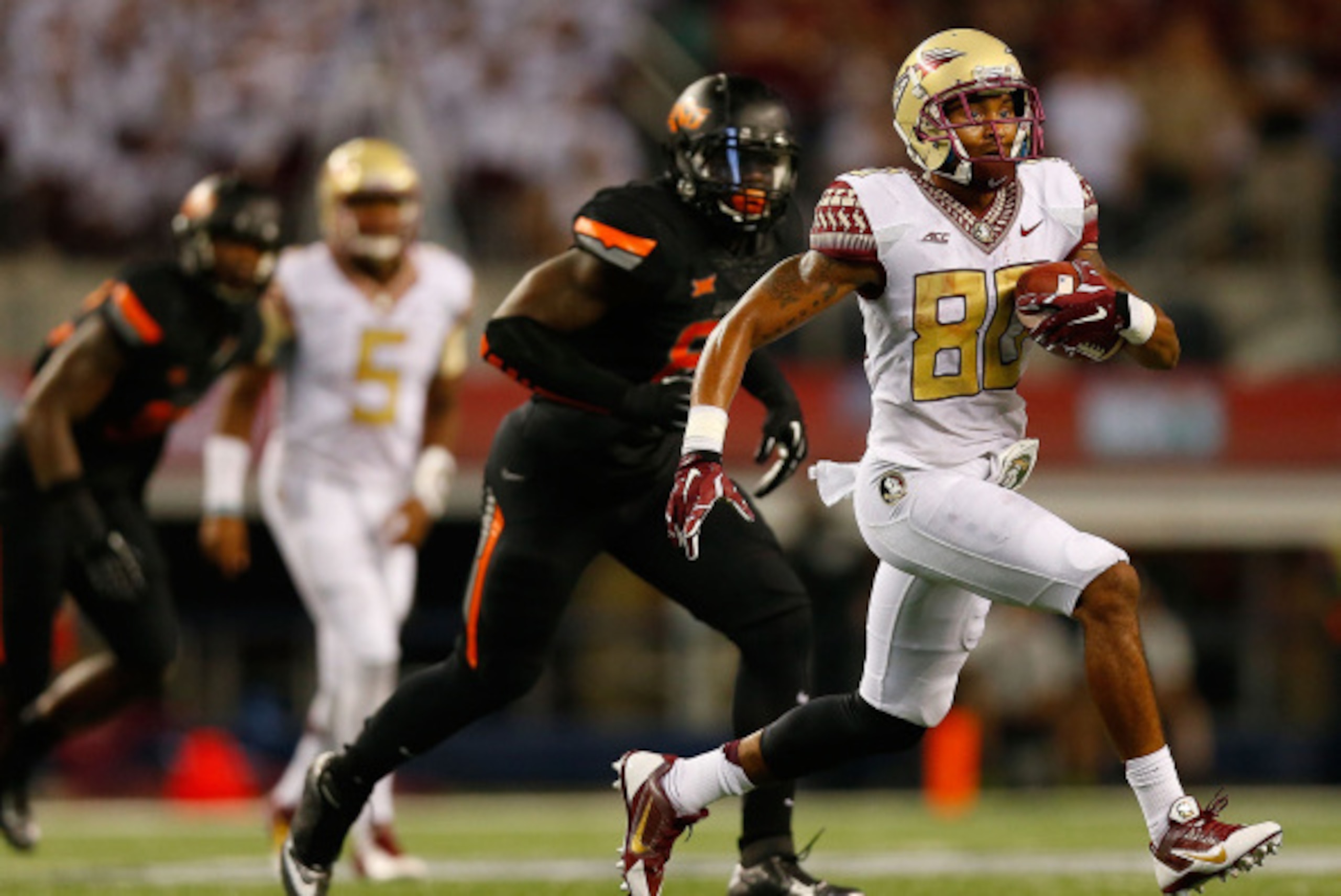 ARLINGTON, TX - AUGUST 30:  Rashad Greene #80 of the Florida State Seminoles carries the ball against the Oklahoma State Cowboys in the second half of the Advocare Cowboys Classic at AT&T Stadium on August 30, 2014 in Arlington, Texas.  (Photo by Tom Penn