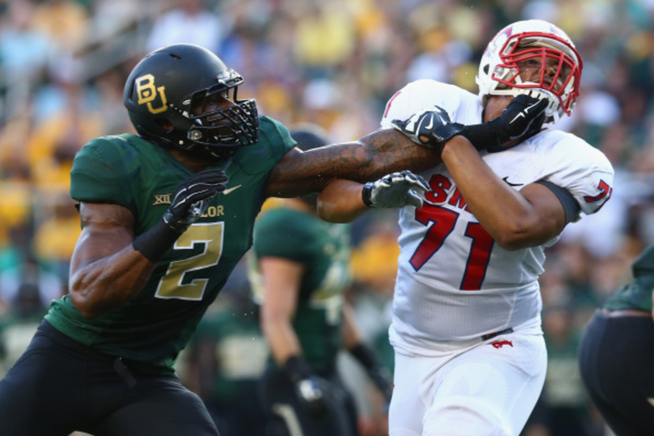 WACO, TX - AUGUST 31:  (L-R) Shawn Oakman #2 of the Baylor Bears and Chauncey Briggs #71 of the Southern Methodist Mustangs at McLane Stadium on August 31, 2014 in Waco, Texas.  (Photo by Ronald Martinez/Getty Images)