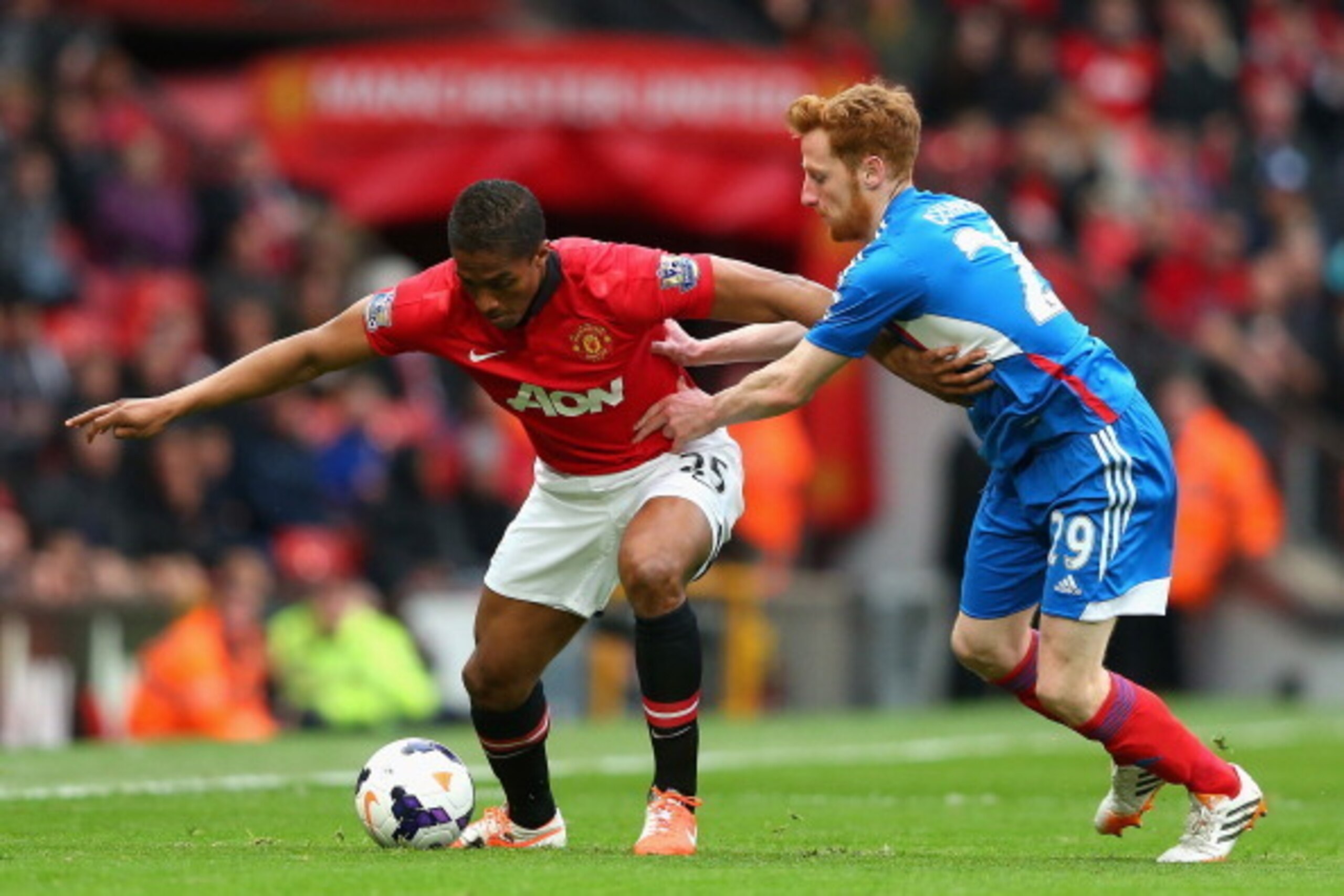 MANCHESTER, ENGLAND - MAY 06:  Luis Antonio Valencia of Manchester United competes with Stephen Quinn of Hull City during the Barclays Premier League match between Manchester United and Hull City at Old Trafford on May 6, 2014 in Manchester, England.  (Ph