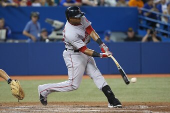 TORONTO, CANADA - AUGUST 26: Yoenis Cespedes #52 of the Boston Red Sox hits a single in the fifth inning during MLB game action against the Toronto Blue Jays on August 26, 2014 at Rogers Centre in Toronto, Ontario, Canada. (Photo by Tom Szczerbowski/Getty