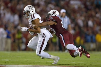 COLUMBIA, SC - AUGUST 28: T.J. Gurley #20 of the South Carolina Gamecocks tackles Sabian Holmes #23 of the Texas A&M Aggies during their game at Williams-Brice Stadium on August 28, 2014 in Columbia, South Carolina. Texas A&M won 52-28. (Photo by Grant Ha