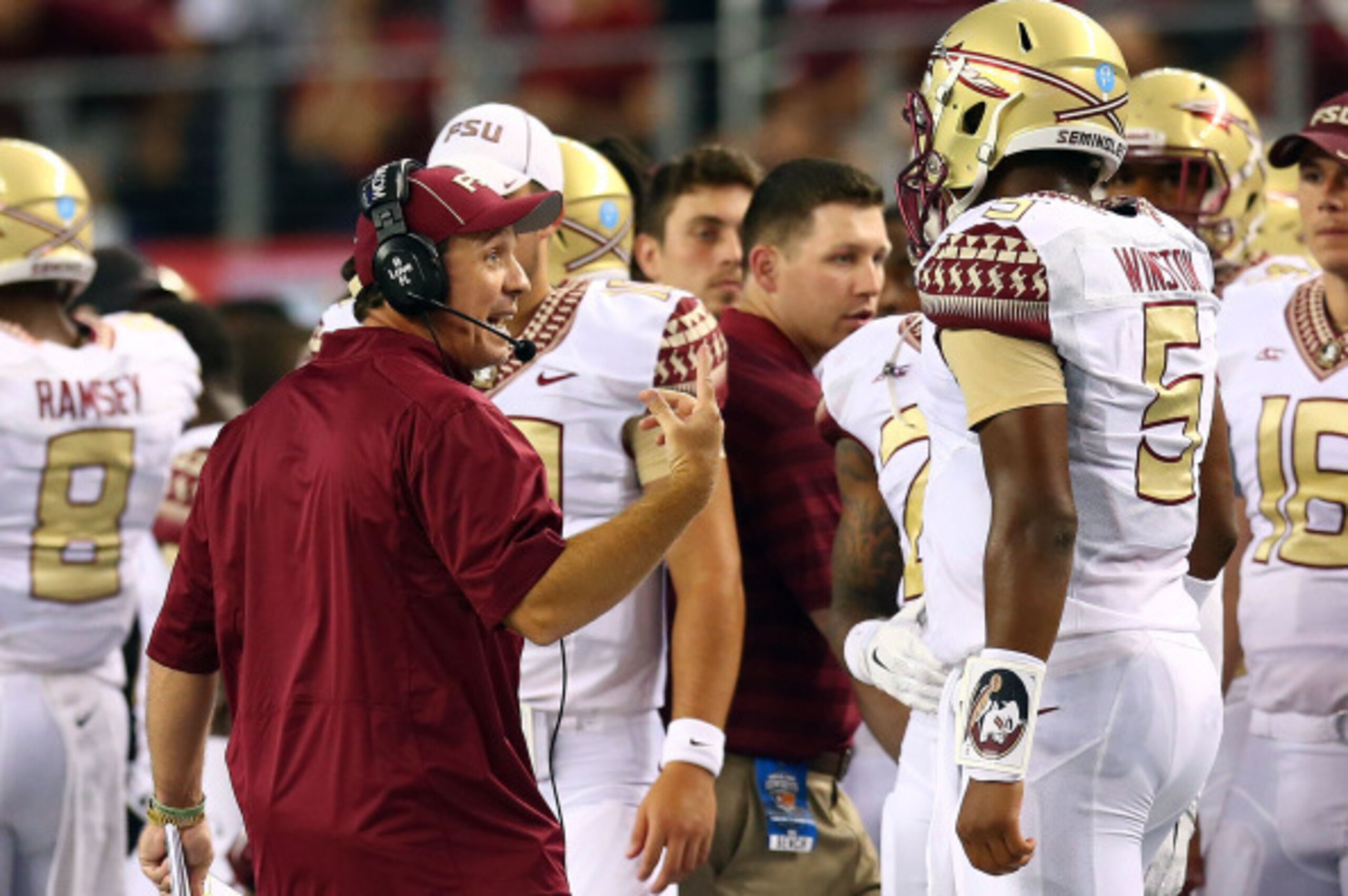 ARLINGTON, TX - AUGUST 30:  Florida State Seminoles head coach Jimbo Fisher talks to Jameis Winston #5 in the first half of the Advocare Cowboys Classic against the Oklahoma State Cowboys at AT&T Stadium on August 30, 2014 in Arlington, Texas.  (Photo by 