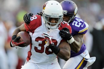 MINNEAPOLIS, MN - AUGUST 16: Captain Munnerlyn #24 of the Minnesota Vikings tackles Andre Ellington #38 of the Arizona Cardinals during the first quarter of the preseason game on August 16, 2014 at TCF Bank Stadium in Minneapolis, Minnesota. (Photo by Han